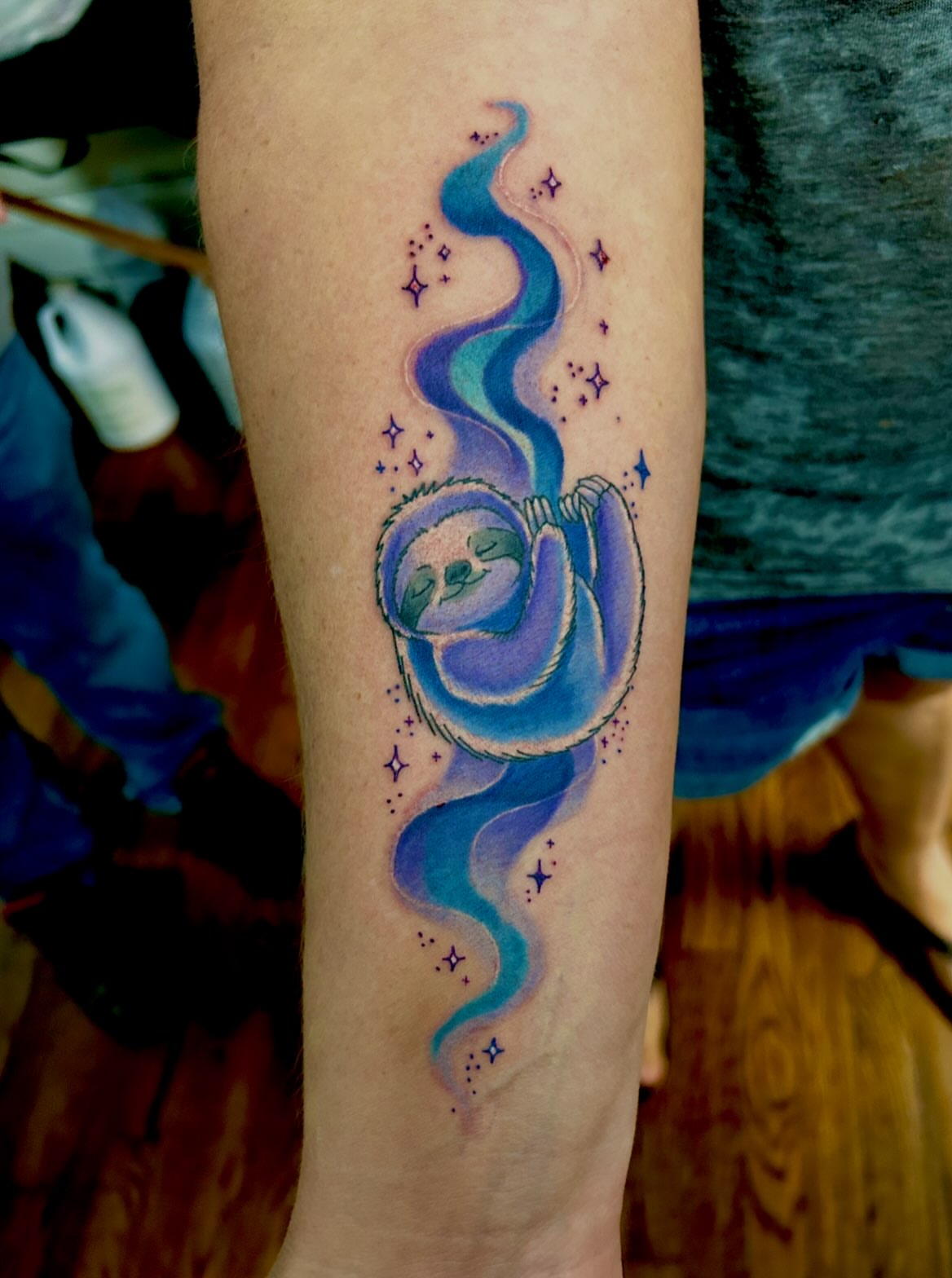 Sleeping sloth dotwork tattoo on the forearm by Austin Young