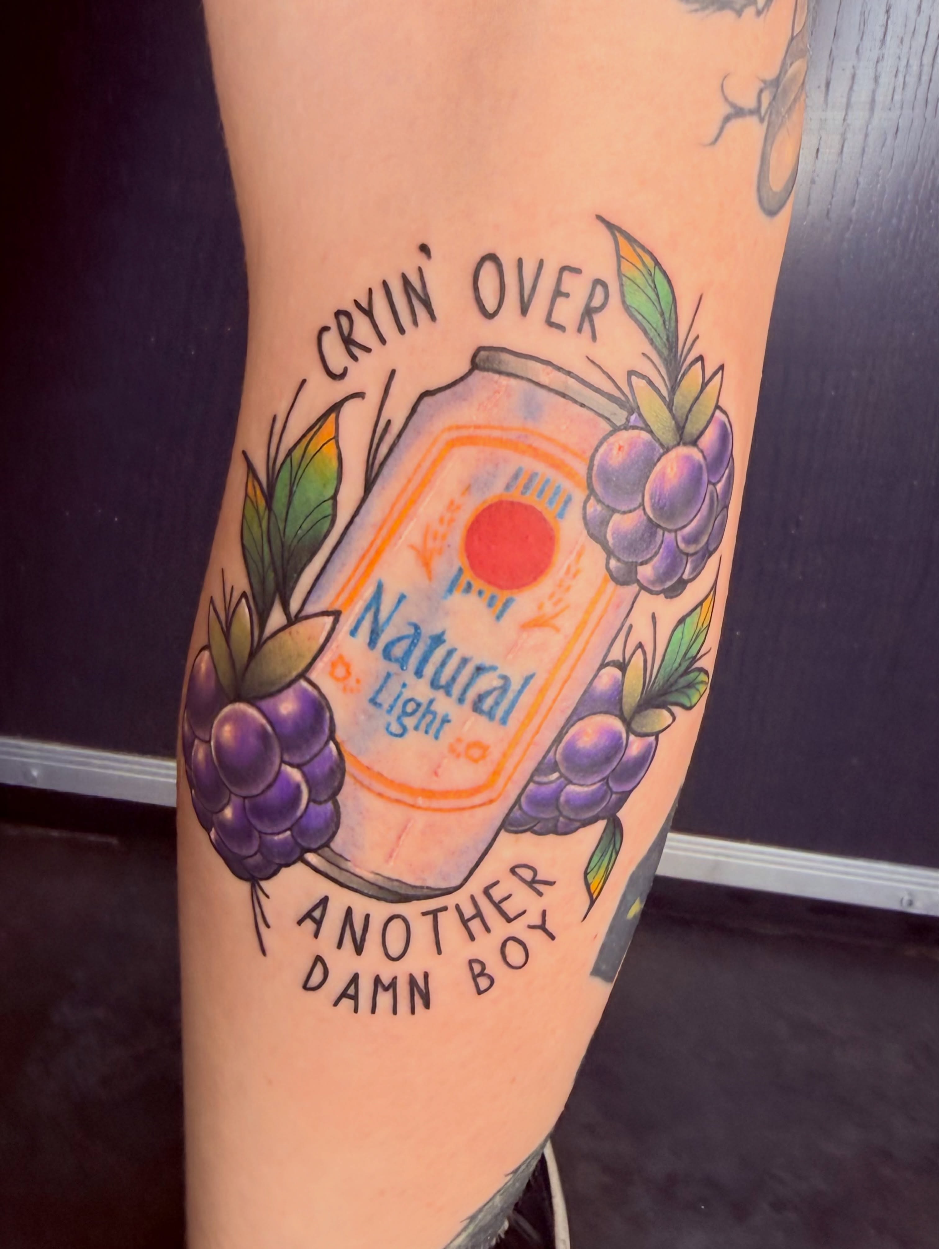 Natural Light beer bottle American traditional tattoo on the thigh by Jezza Munson