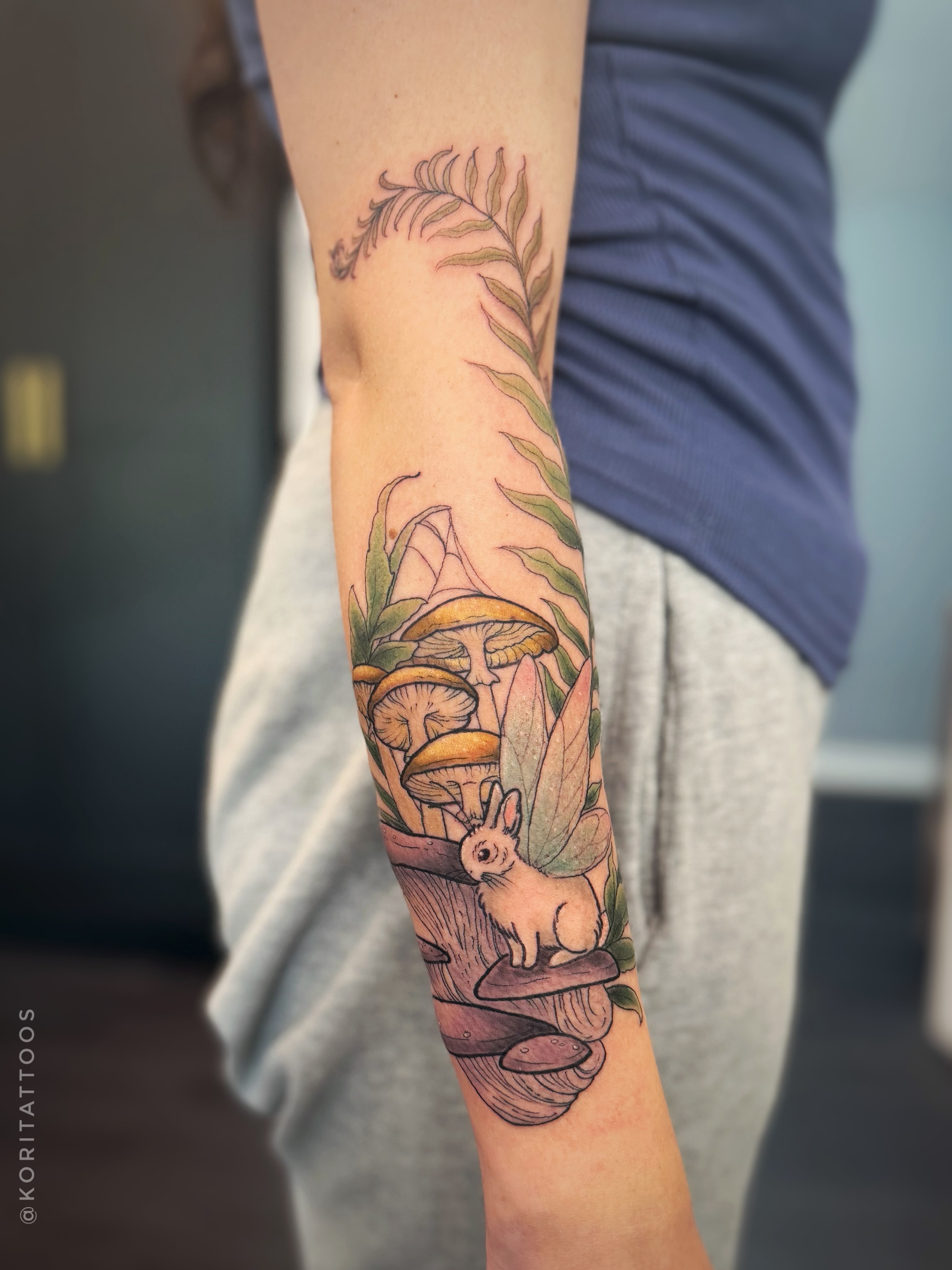 Mushroom and rabbit realism tattoo on the forearm by Kori Millhimes