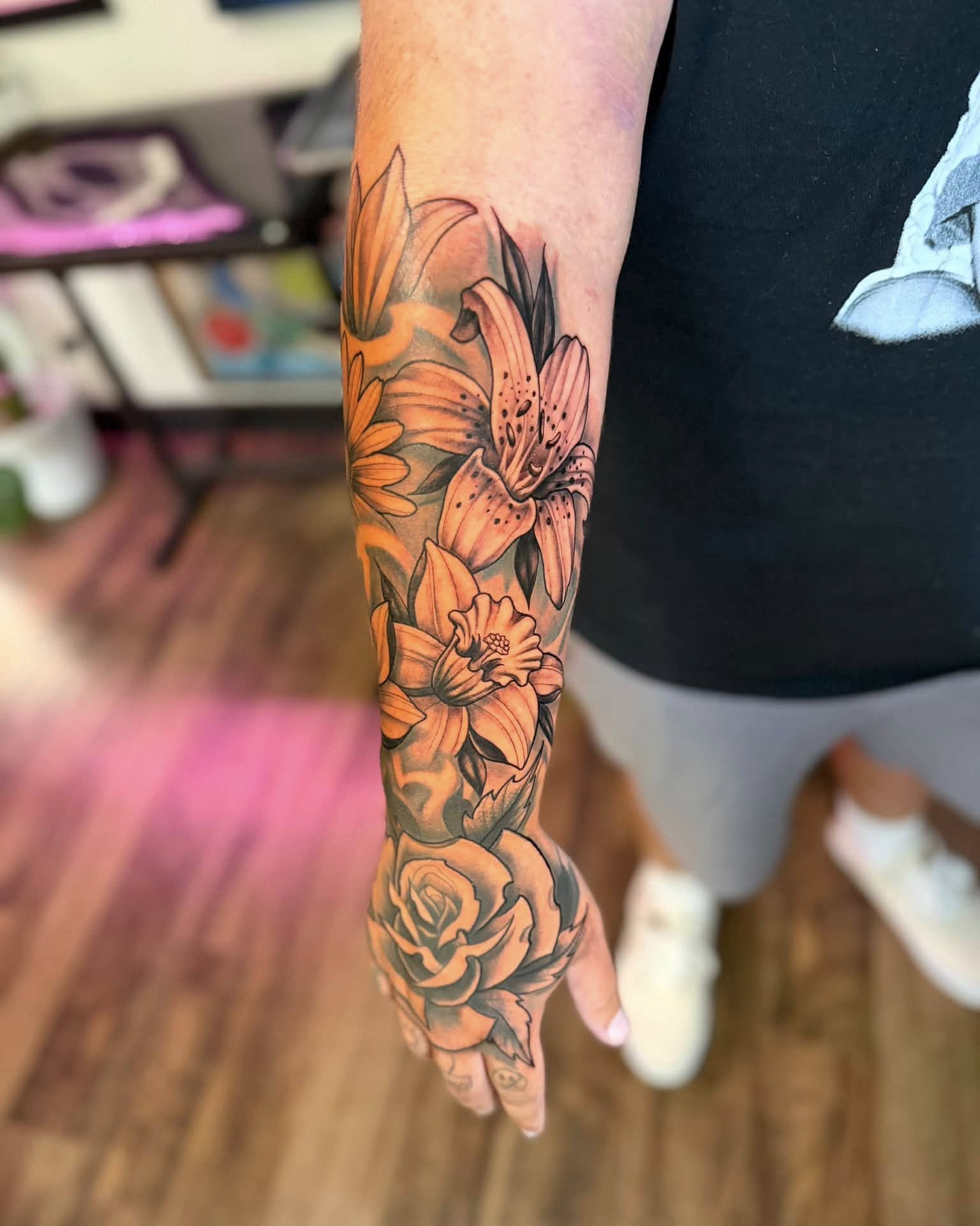 Floral bouquet realism tattoo on the forearm by Chad Meado