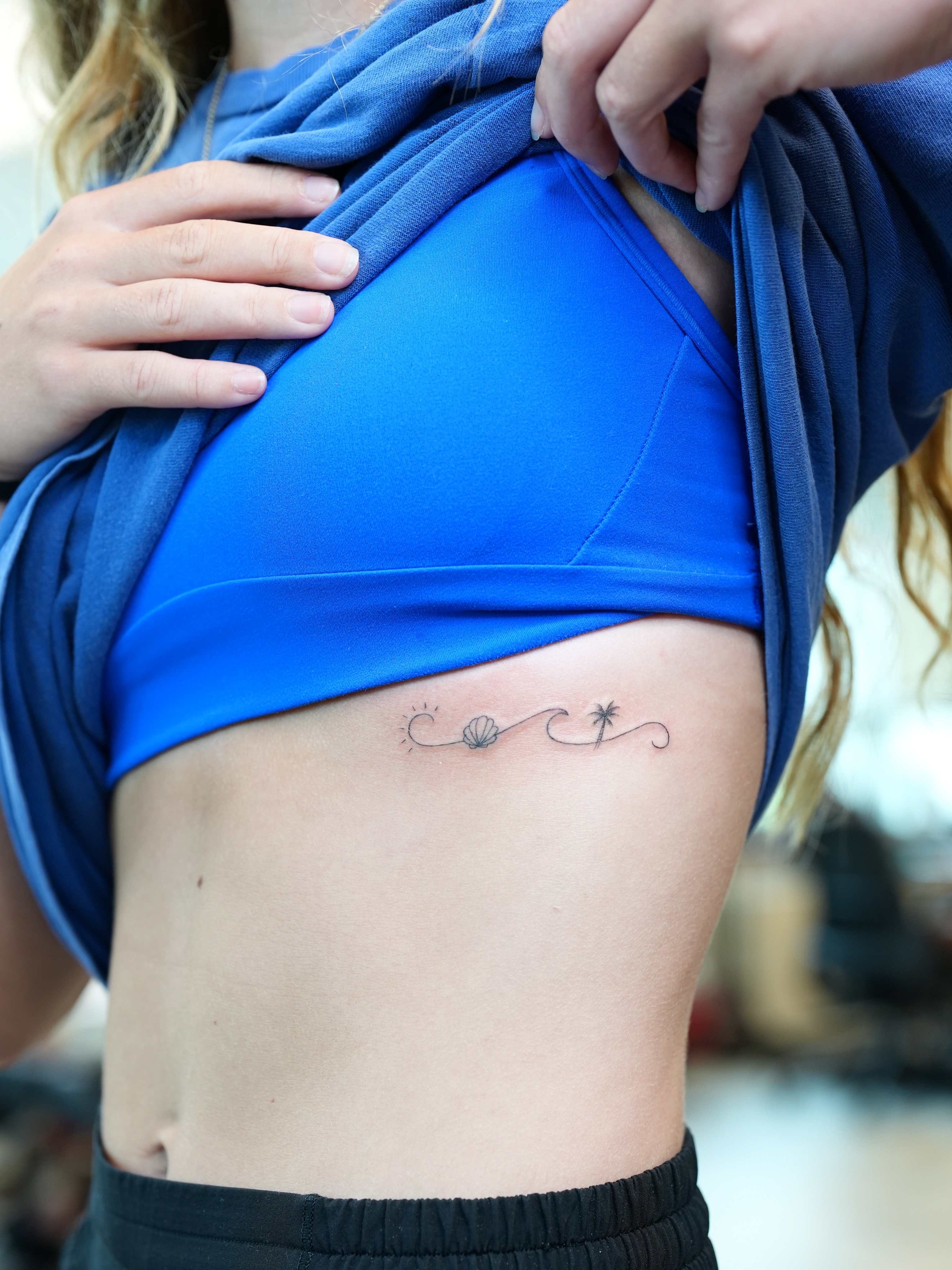 Seashell and waves geometric tattoo on the ribs by Kevin Betancourt