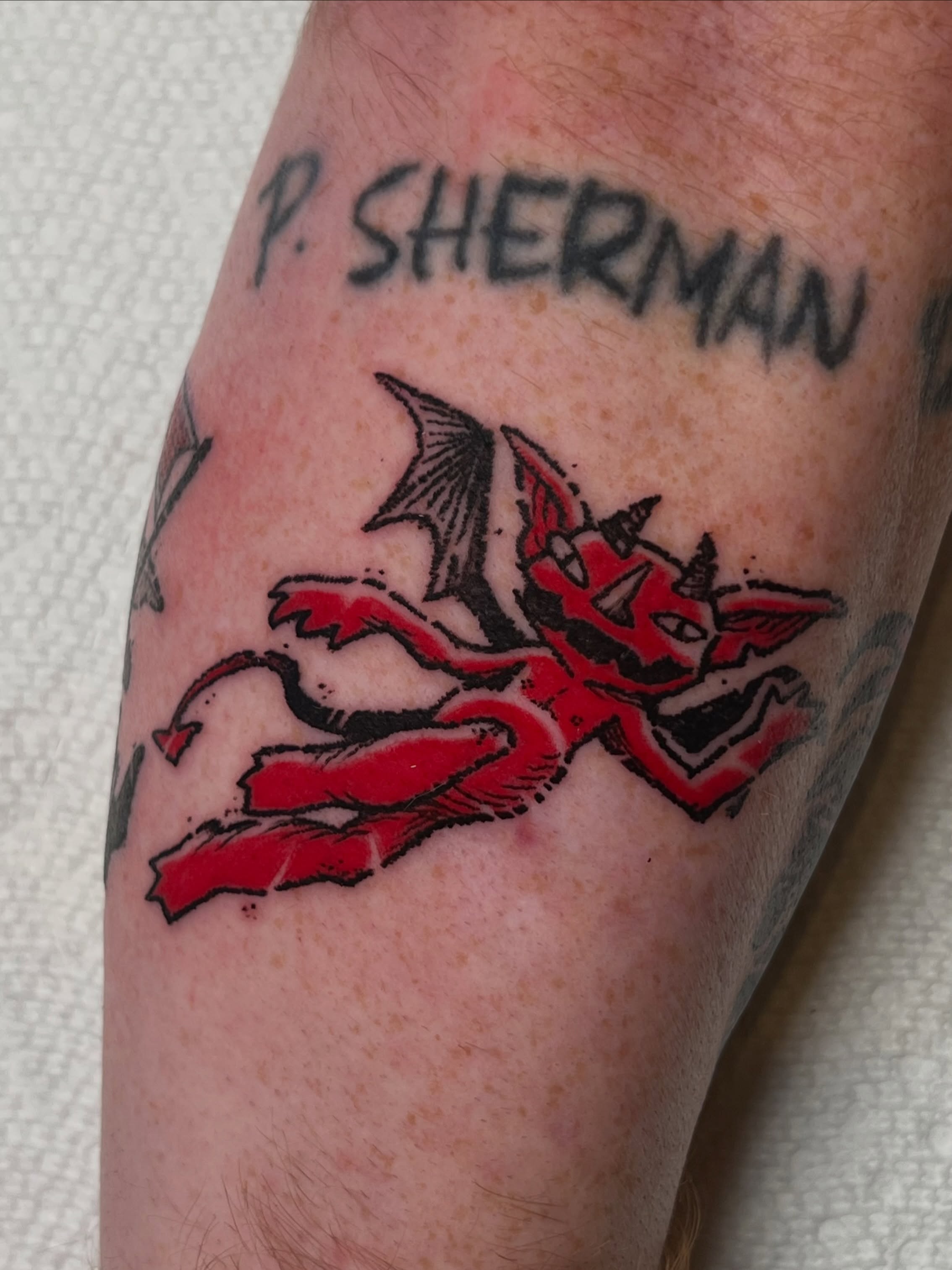 Red dragon American traditional tattoo on the forearm by Millie, Maryville, Tennessee