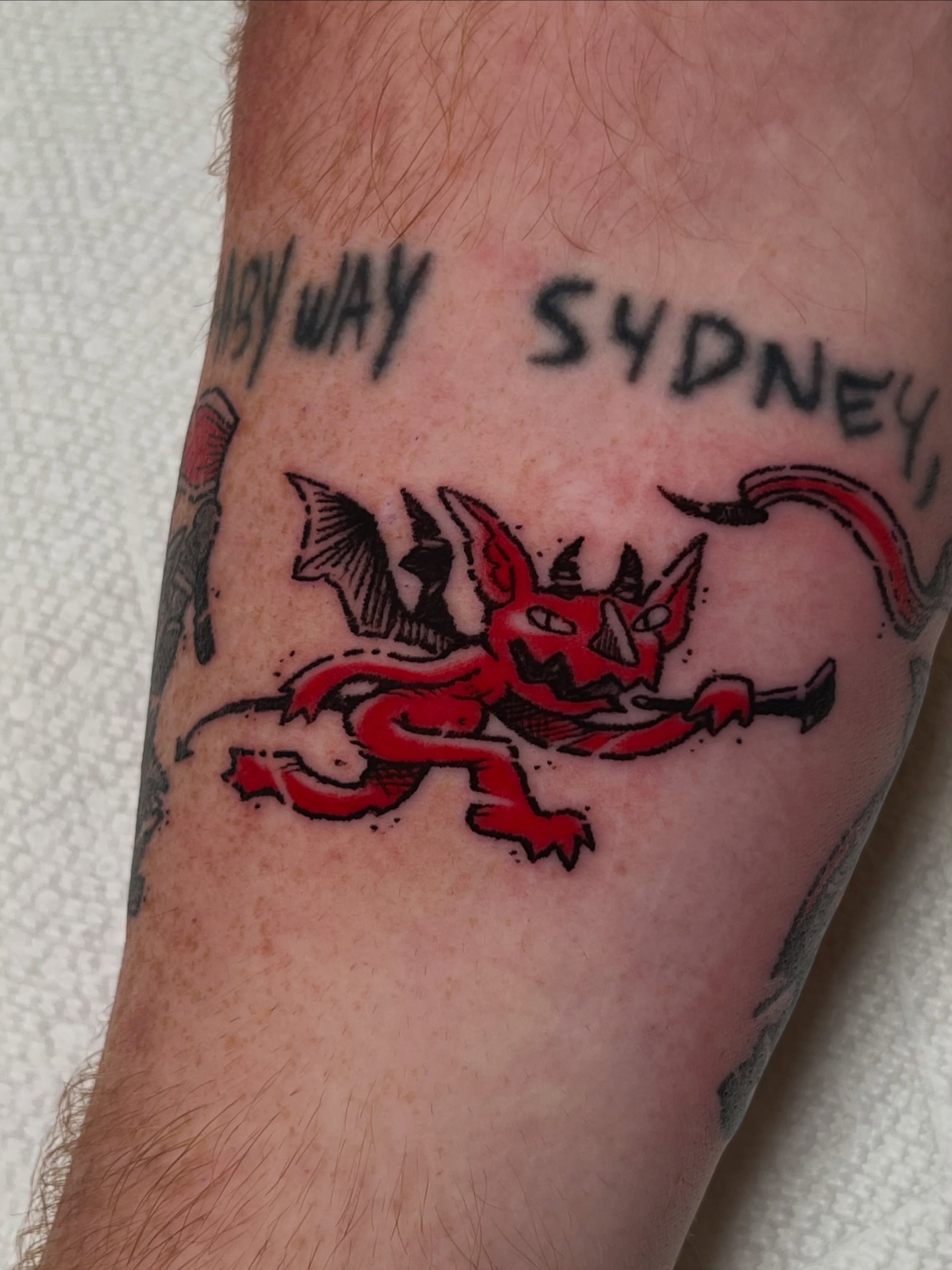 Red devil American traditional tattoo on the forearm by Millie, Maryville, Tennessee