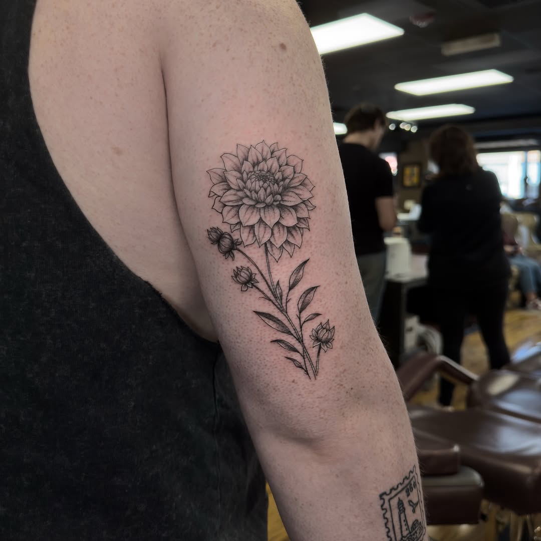 Dahlia flower black and grey tattoo on the forearm by Leo Fernandes, Danvers, Massachusetts