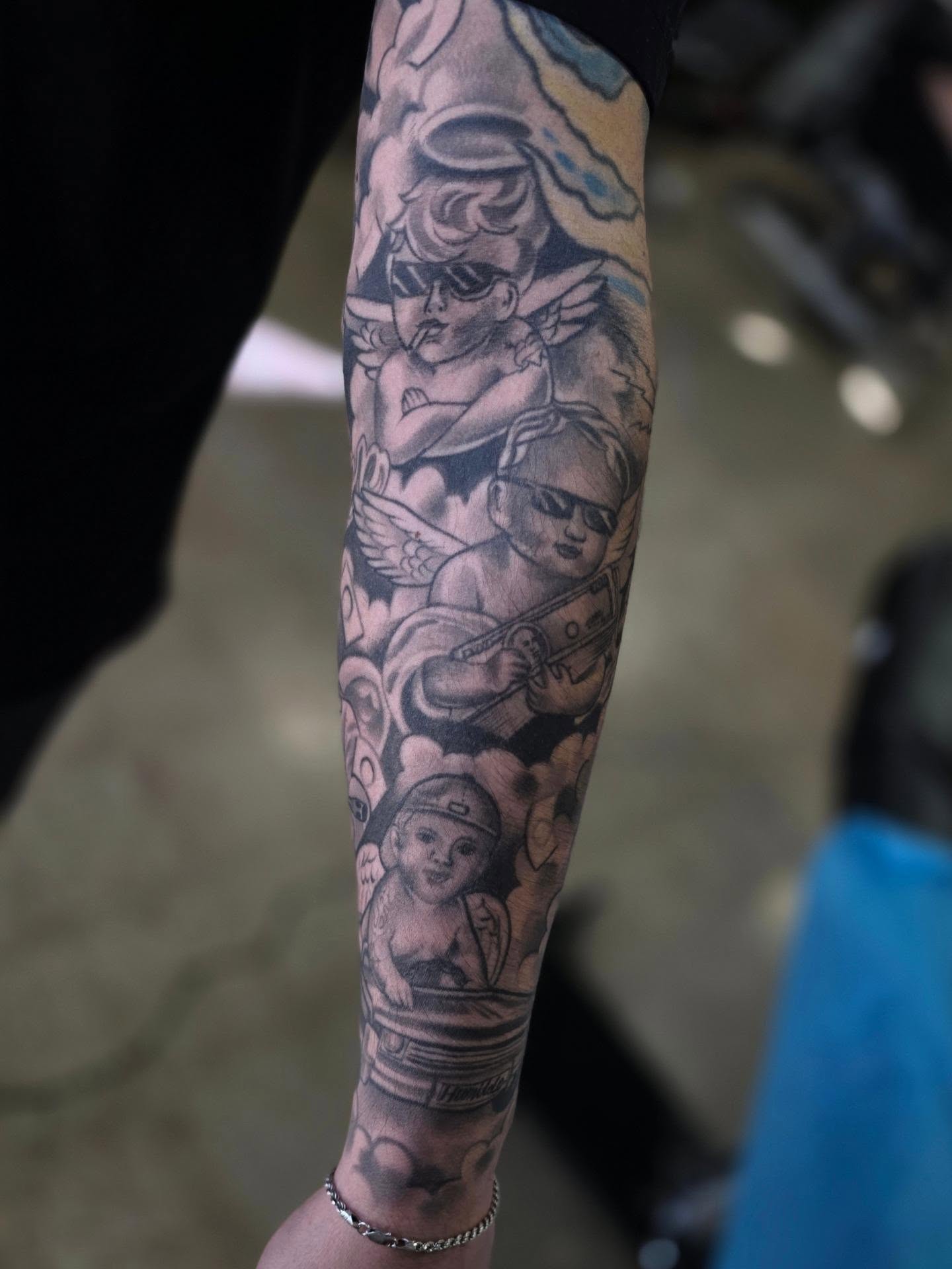Angels and cherubs American traditional tattoo on the forearm by Tattoo Seez, Wichita, Kansas