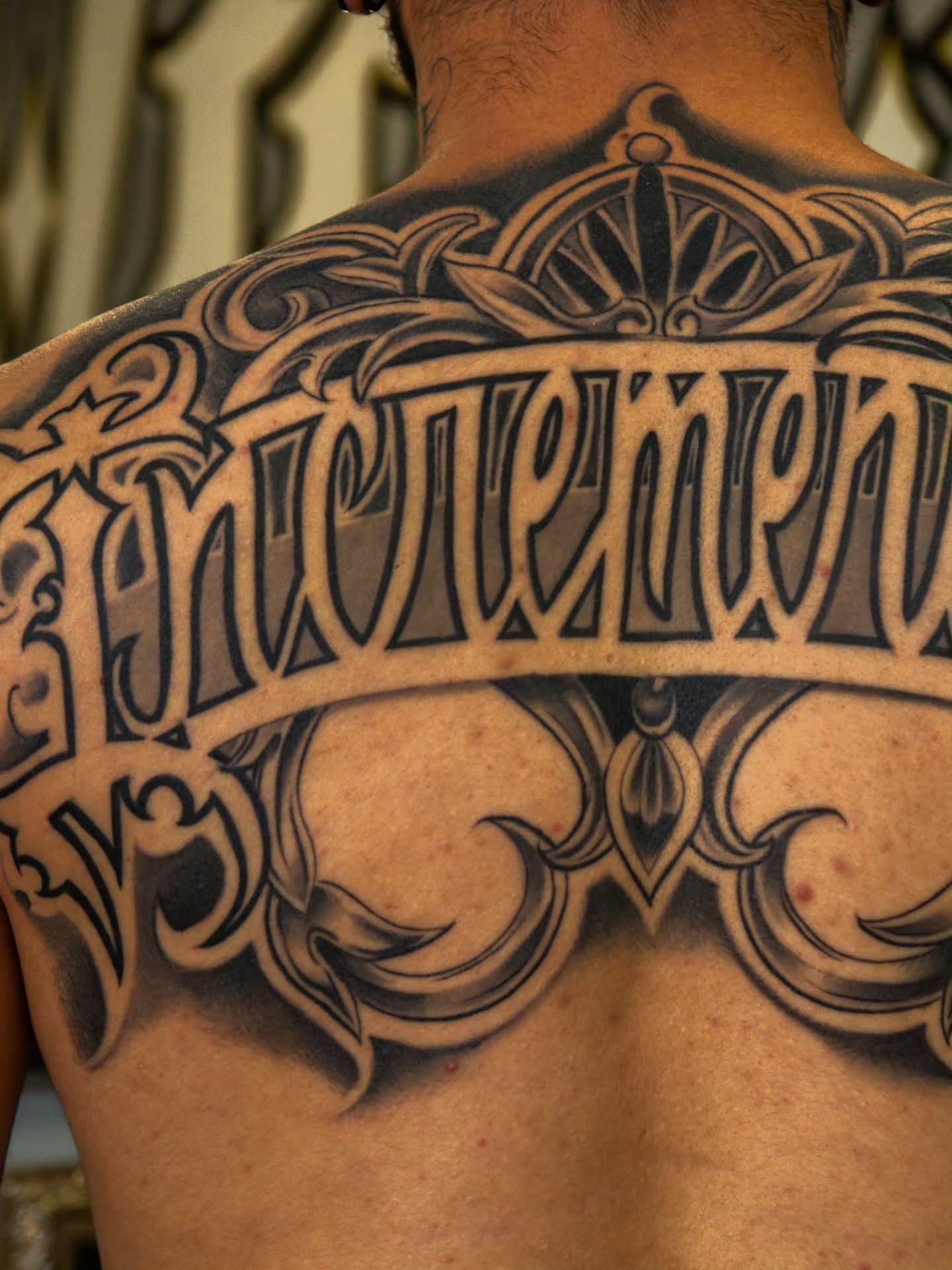 Script lettering lettering script tattoo on the back by Tattoo Seez, Wichita, Kansas