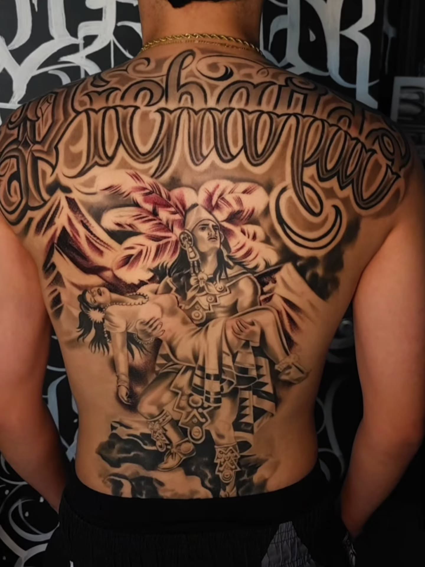 Indigenous warrior realism tattoo on the back by Tattoo Seez, Wichita, Kansas