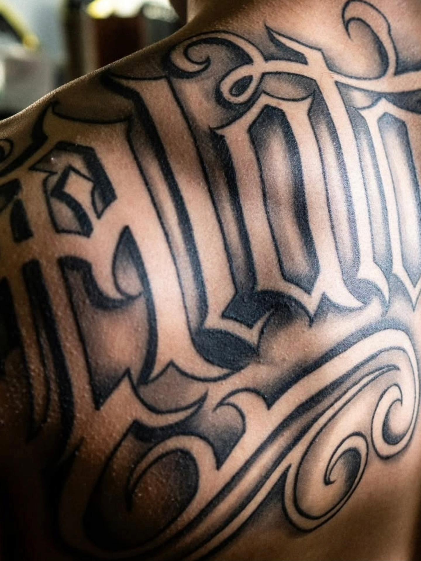 Gothic script black and grey tattoo on the chest by Tattoo Seez, Wichita, Kansas
