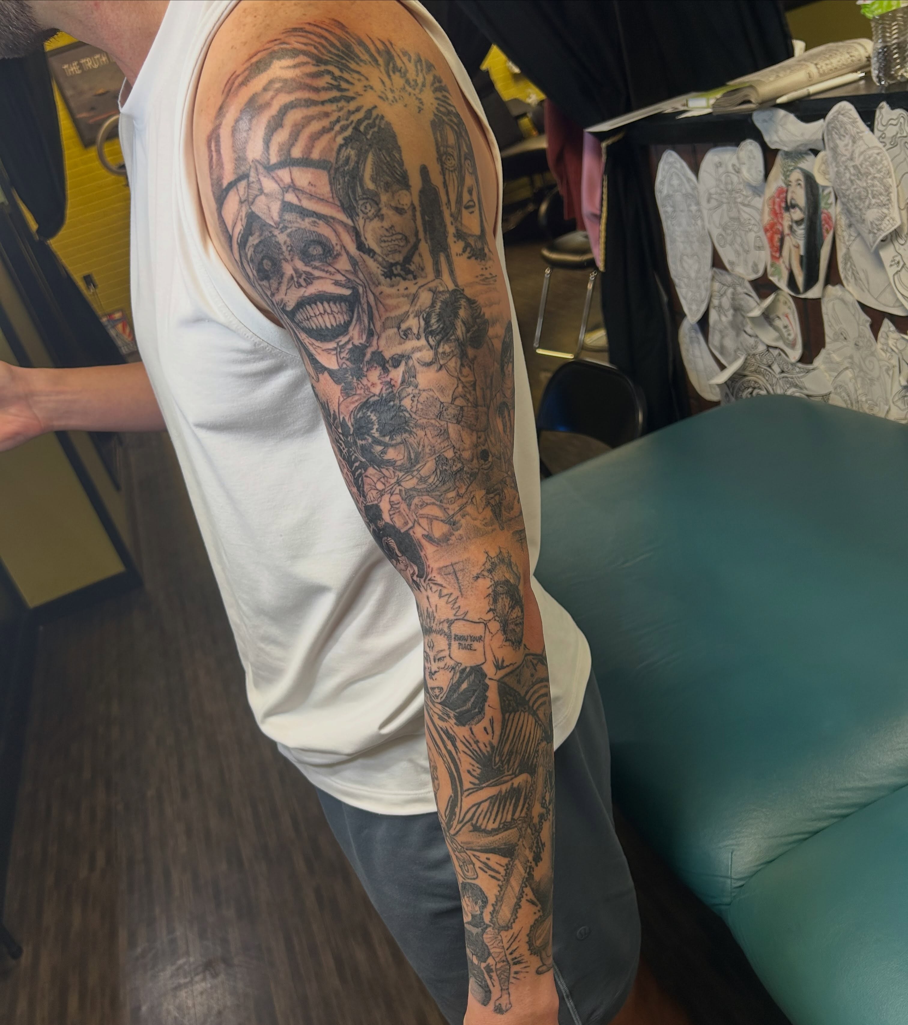 Horror characters dark realism tattoo on the upper arm by Evan