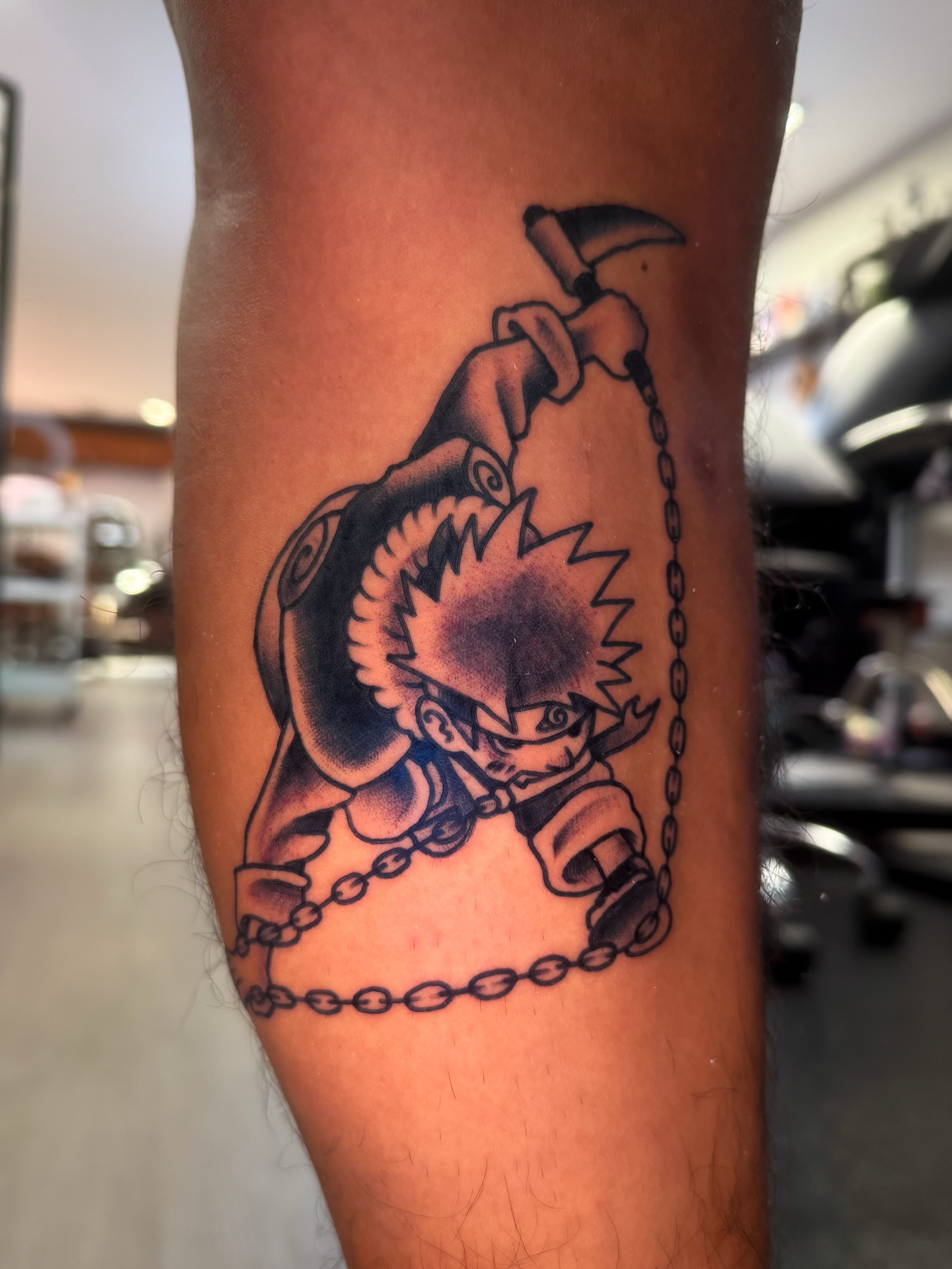 Boy with chains black and grey tattoo on the forearm by Louie Flores