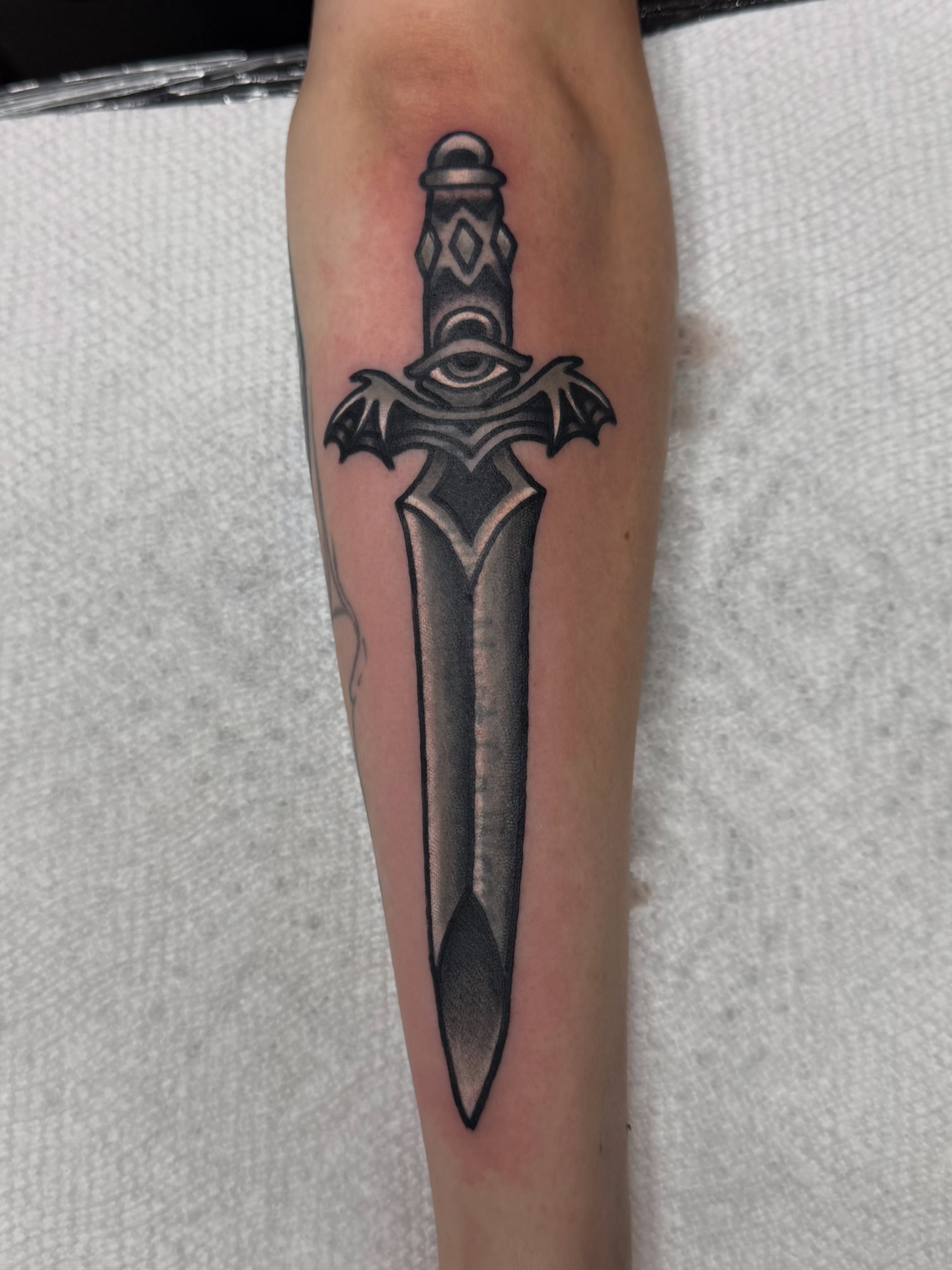Sword black and grey tattoo on the forearm by ๐ฉ๐ฌ๐ค๐๐ซ ๐ฐ๐ฆ๐ค๐ฅ๐ฑ