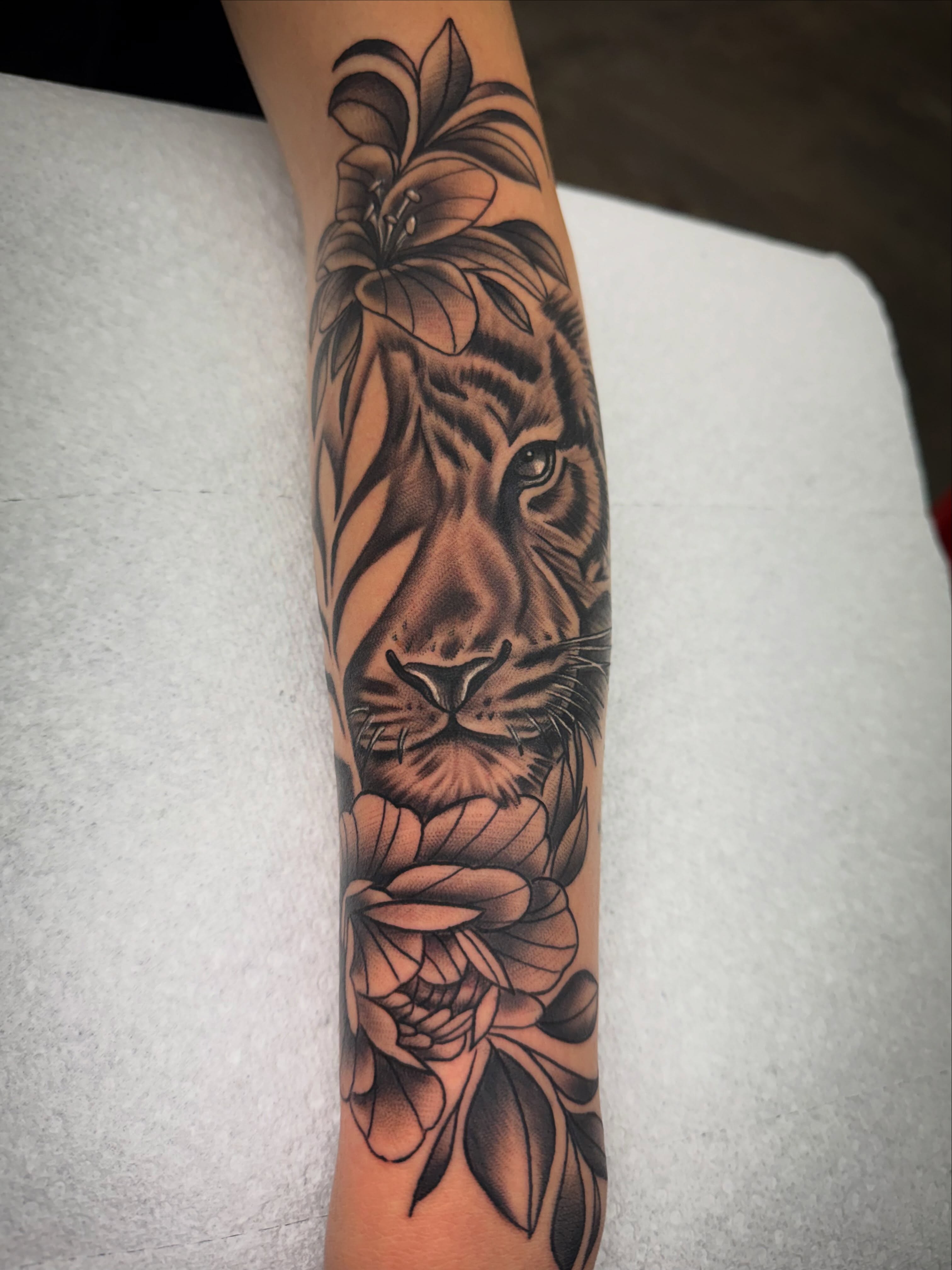 Tiger and lily realism tattoo on the forearm by Jake Horstman, Dayton, Ohio