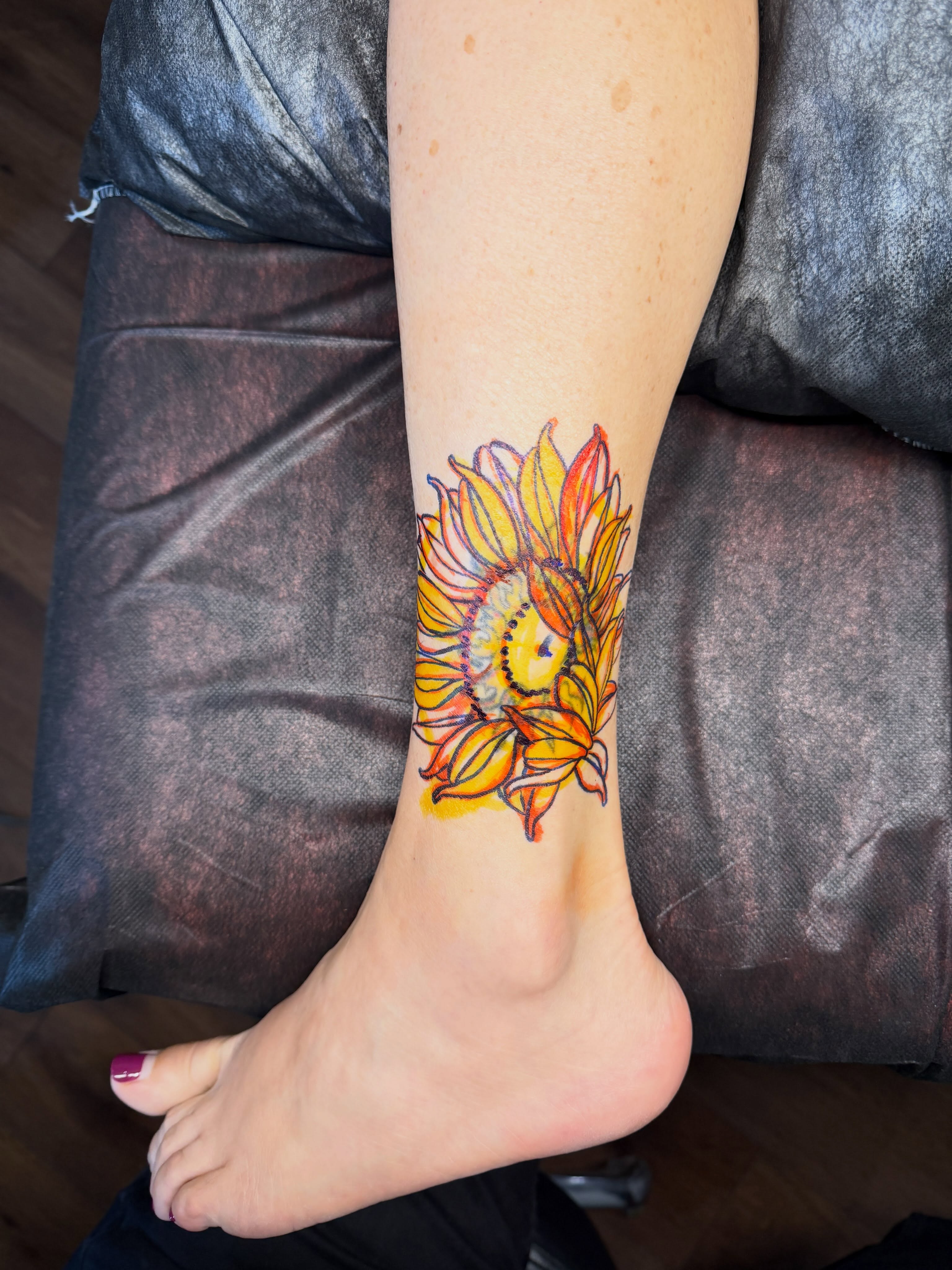 Sunflower new school tattoo on the foot by Brad Snow