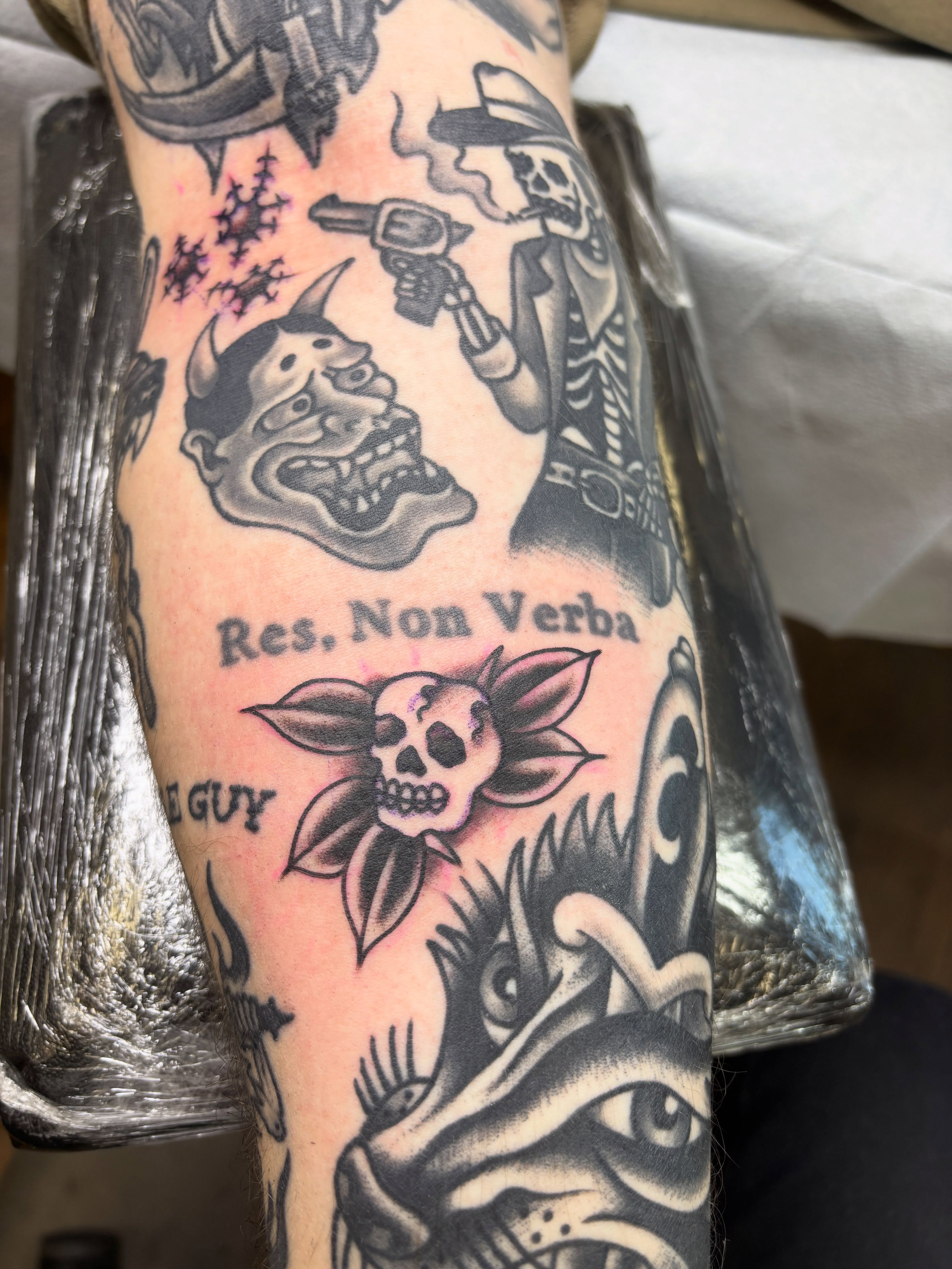 Res non verba American traditional tattoo on the forearm by Mike DiCicco