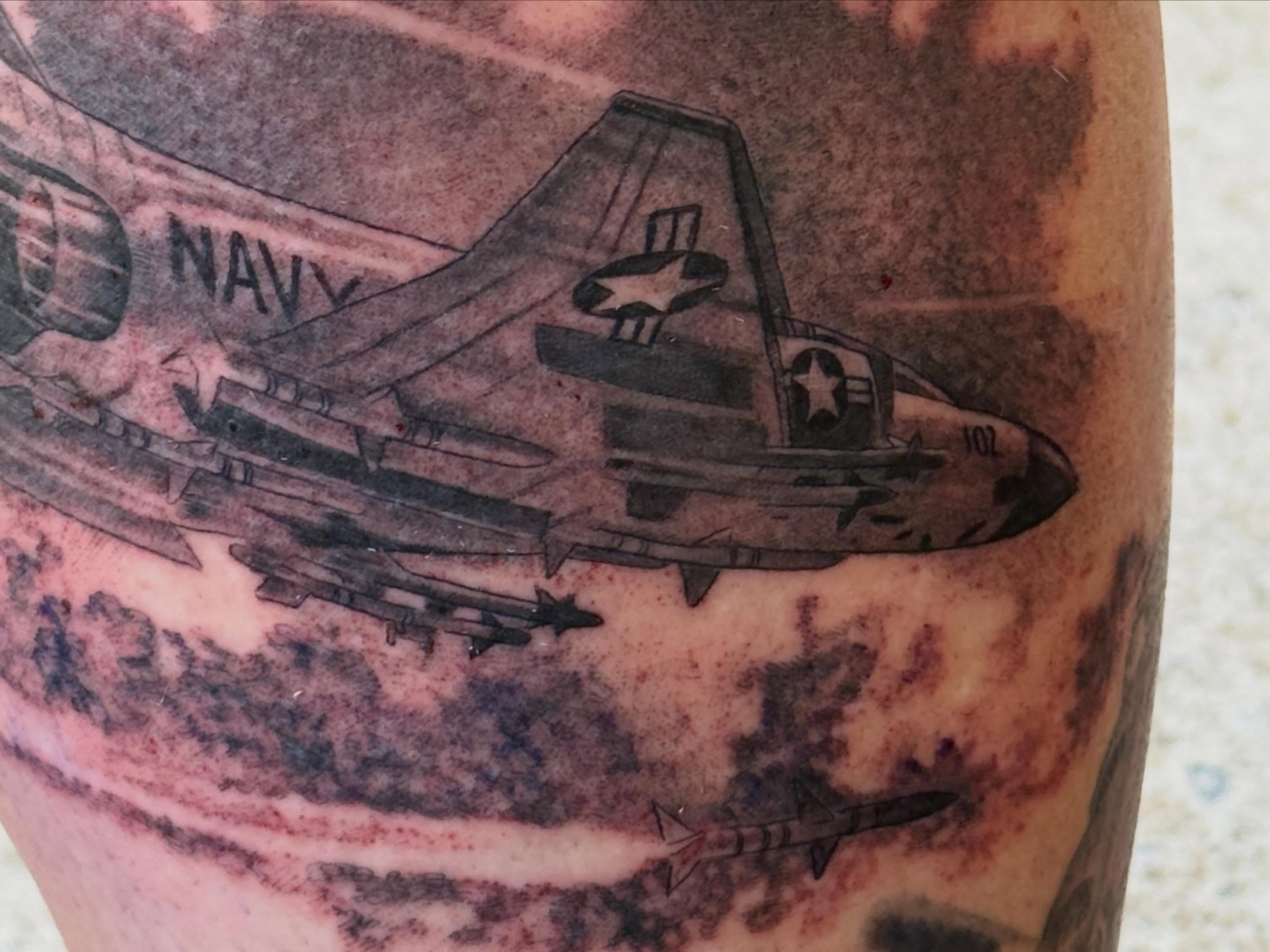 Navy jet with bombs black and grey tattoo on the forearm by Hori Bensei, Charlottesville, Virginia