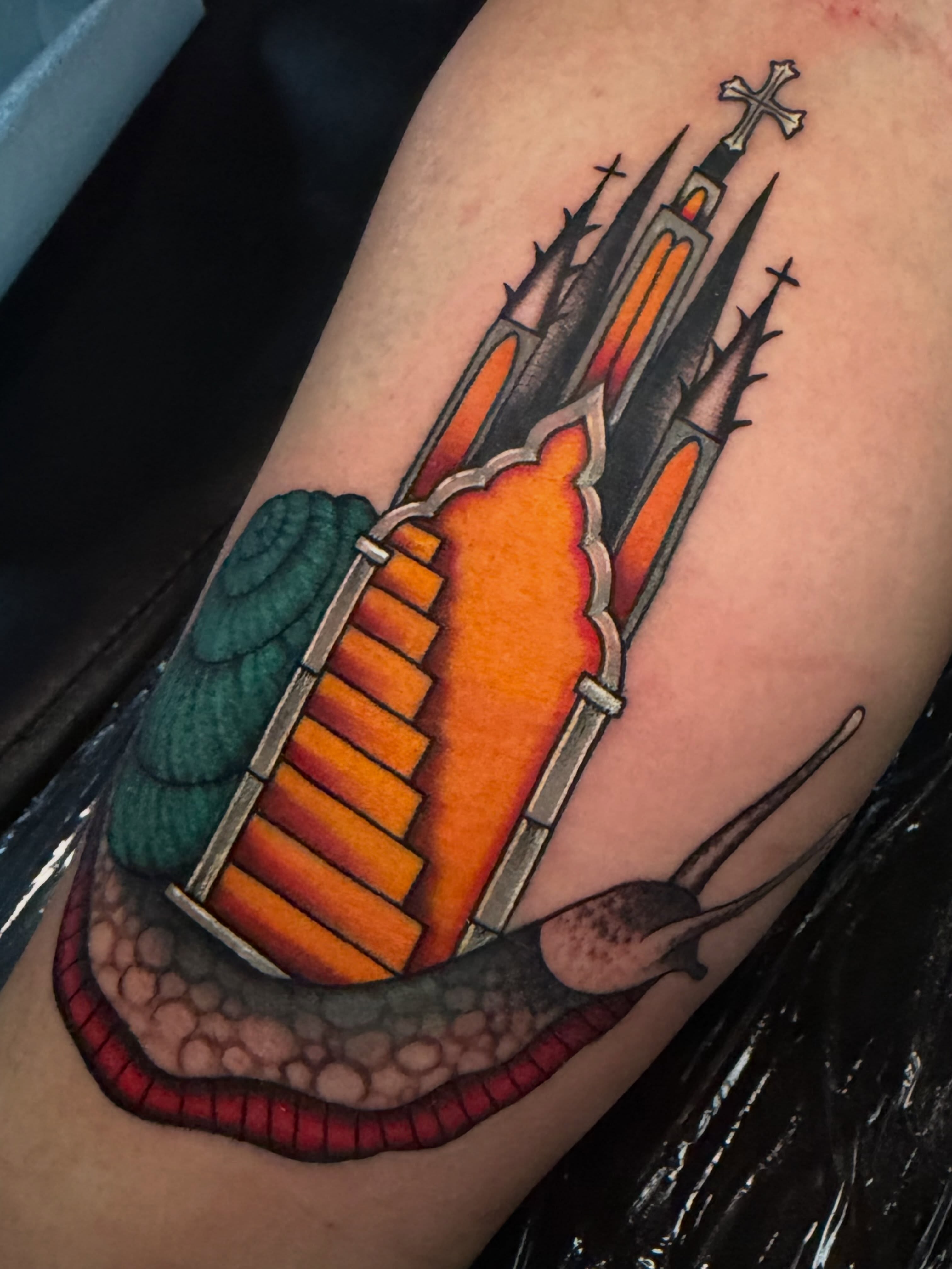 Church and snail American traditional tattoo on the forearm by Madison ‘Maddog’ Stewart