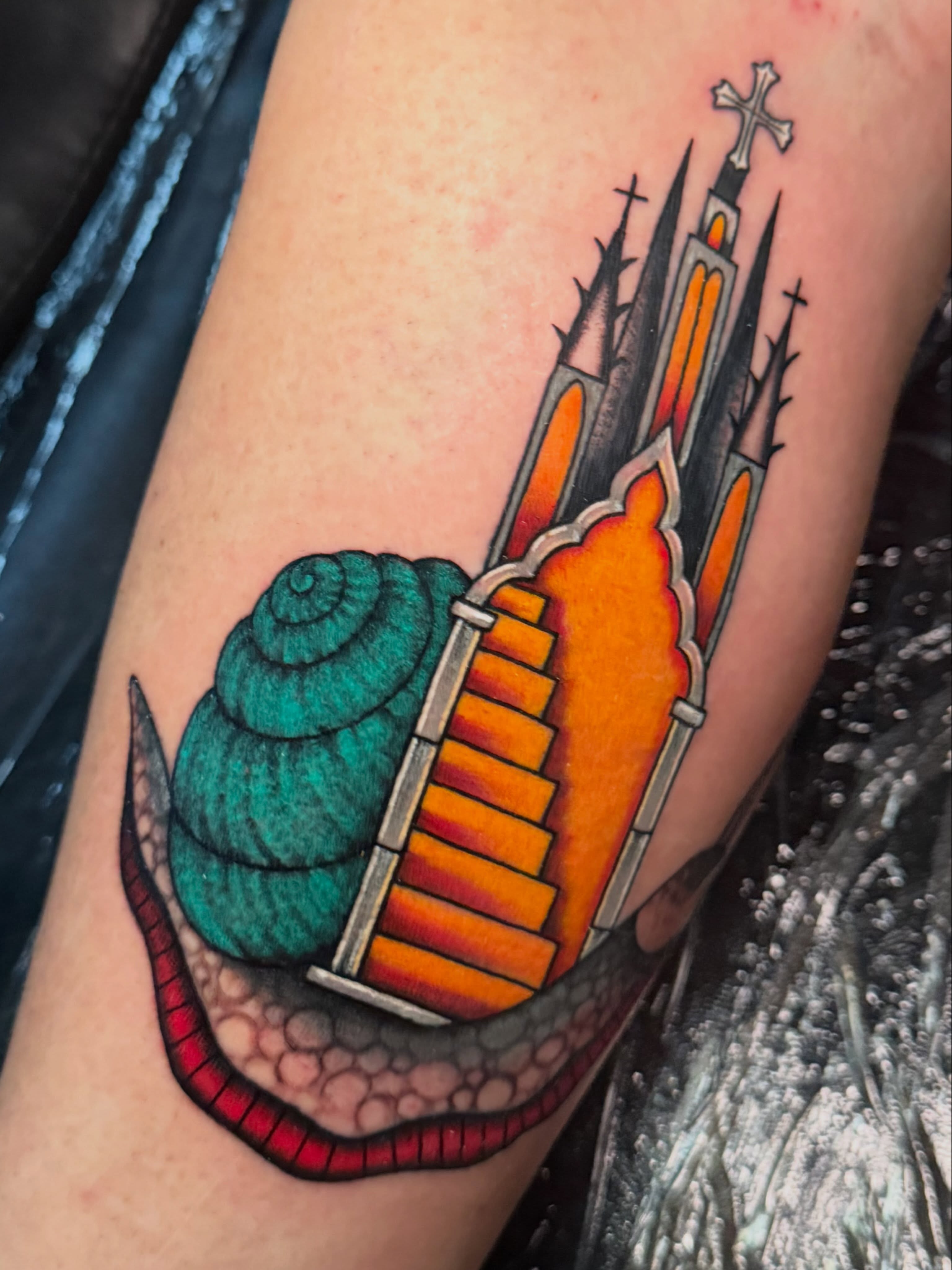 Church and snail American traditional tattoo on the forearm by Madison ‘Maddog’ Stewart