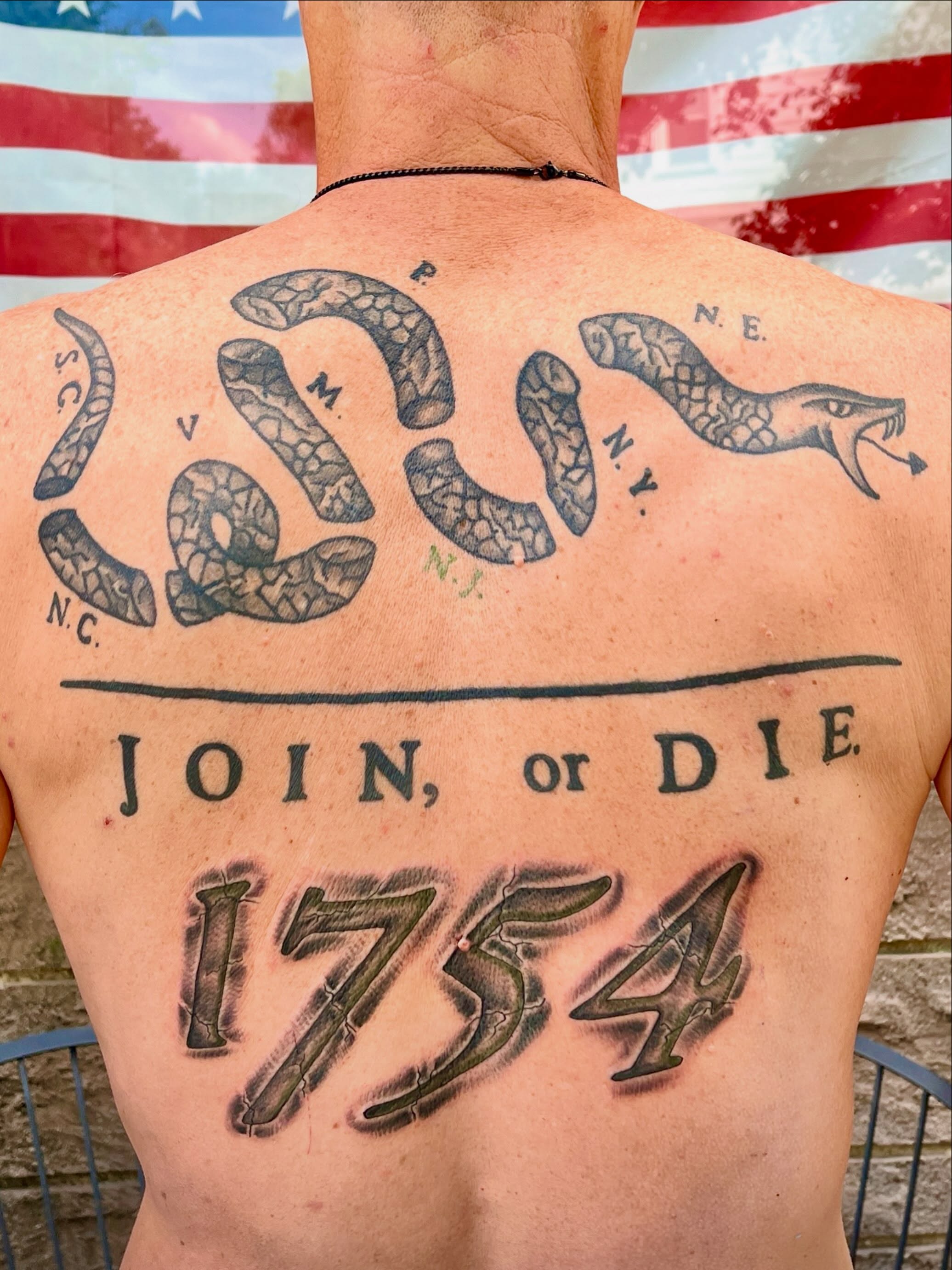 Snake and motto American traditional tattoo on the back by Suzanne B