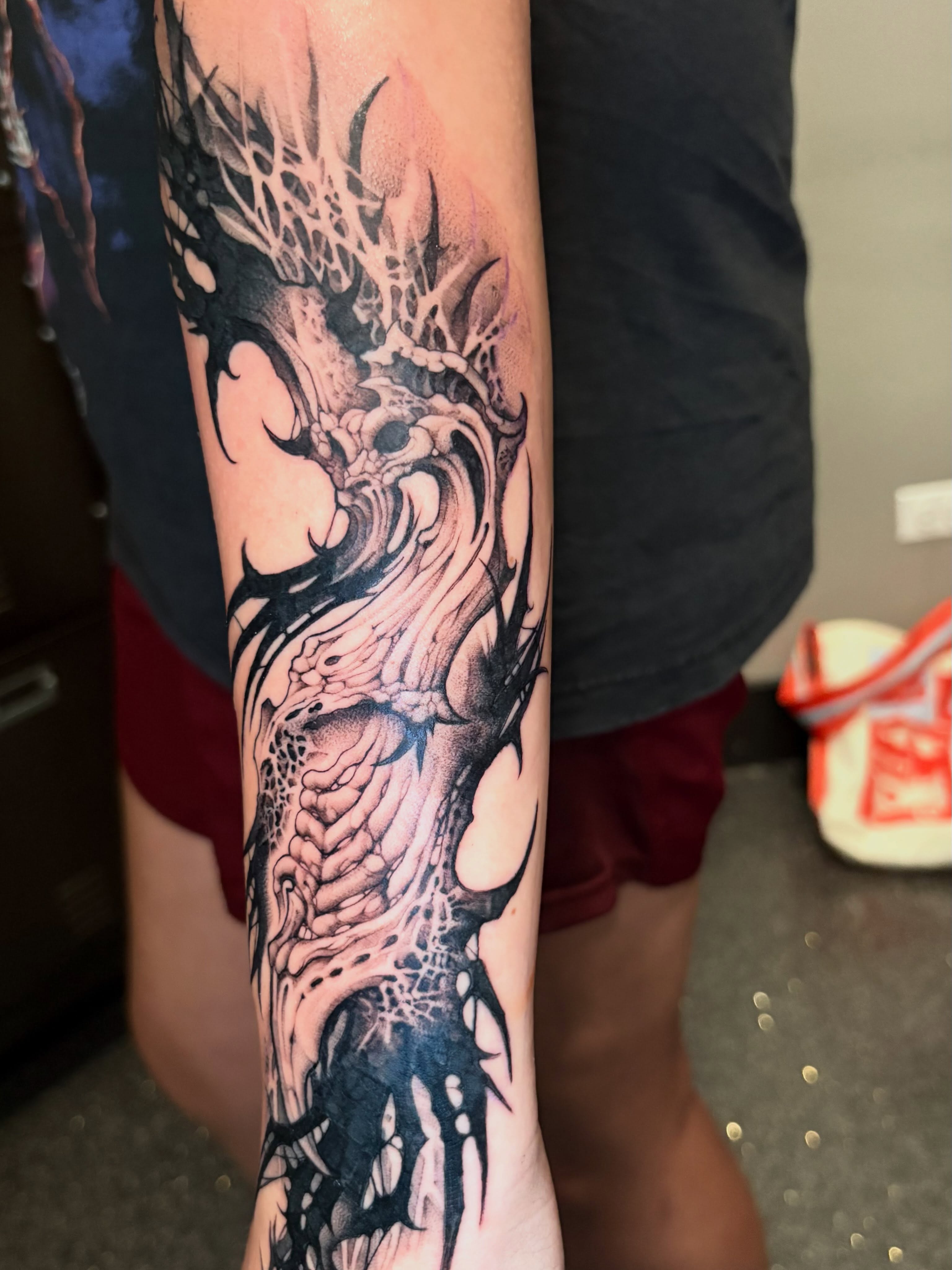 Dragon realism tattoo on the forearm by Eddie Wolfe