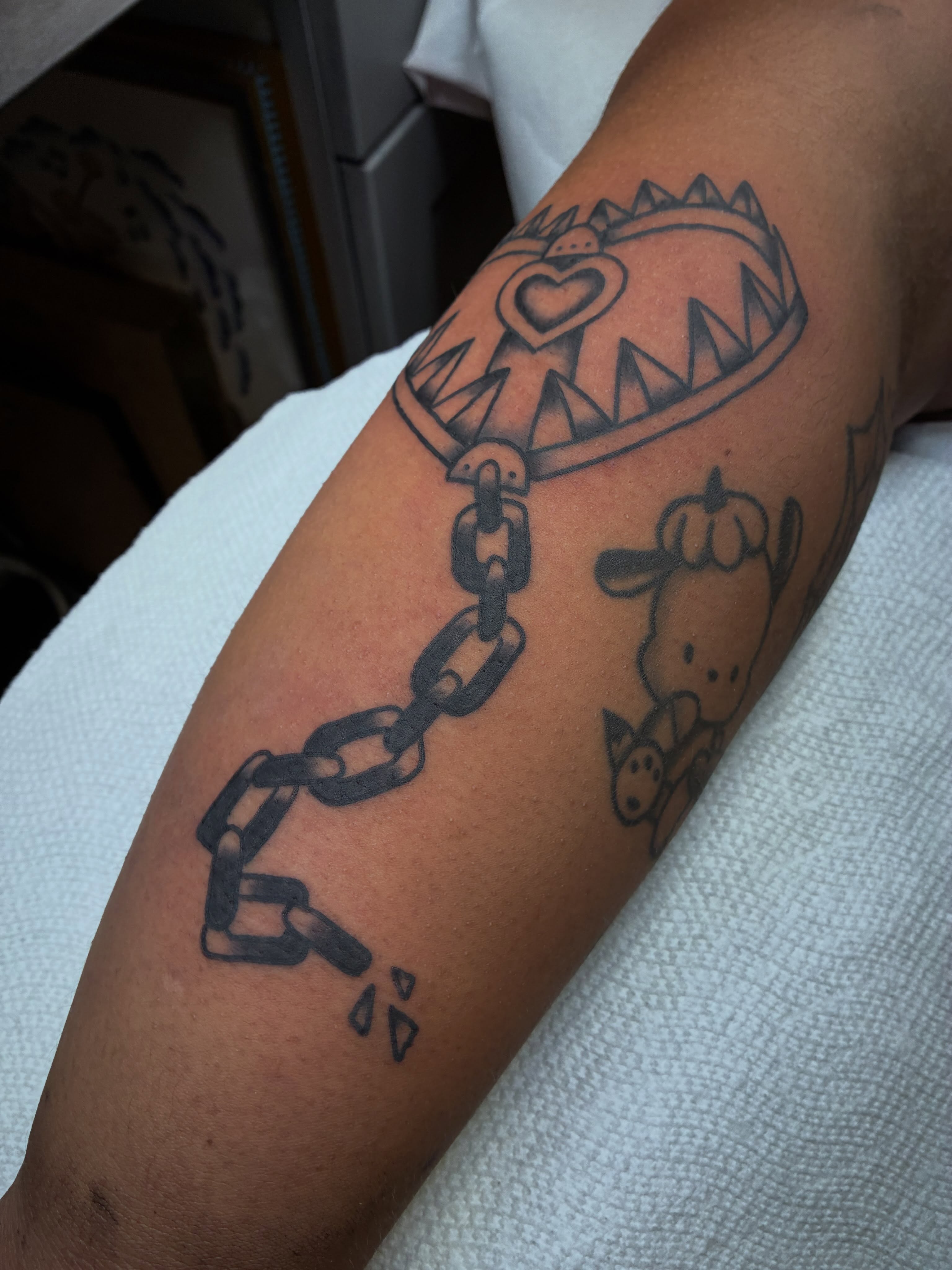 Heart and chain black and grey tattoo on the forearm by @rubber_band_dan, San Francisco, California