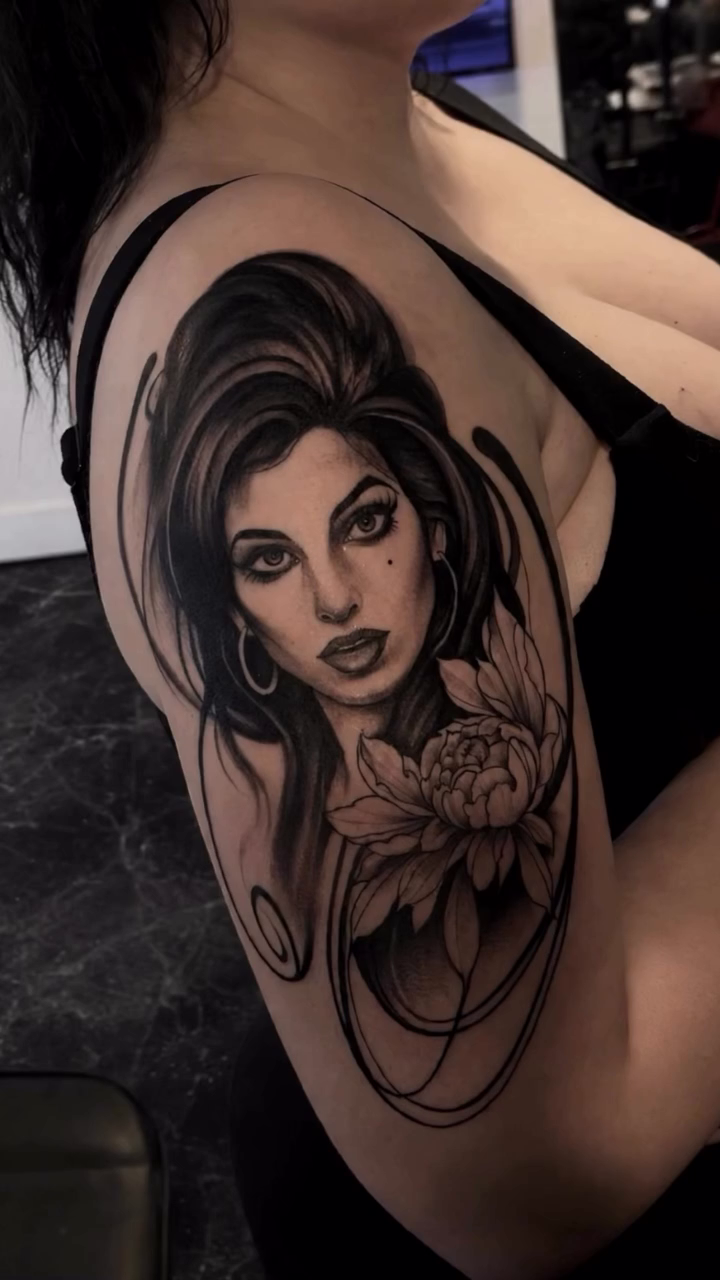 Woman with flower realism tattoo by Turk