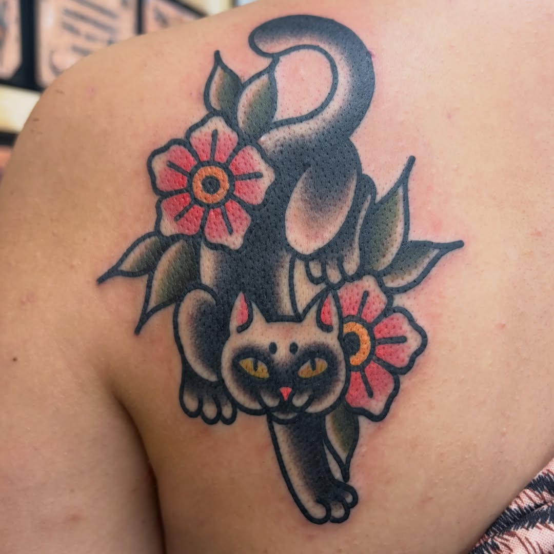 Cat and flowers American traditional tattoo on the shoulder by Adrian Godoy