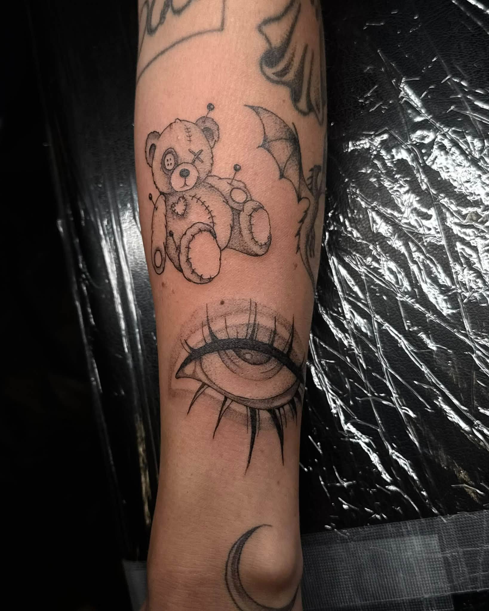 Teddy bear black and grey tattoo on the forearm by Madison Jasso