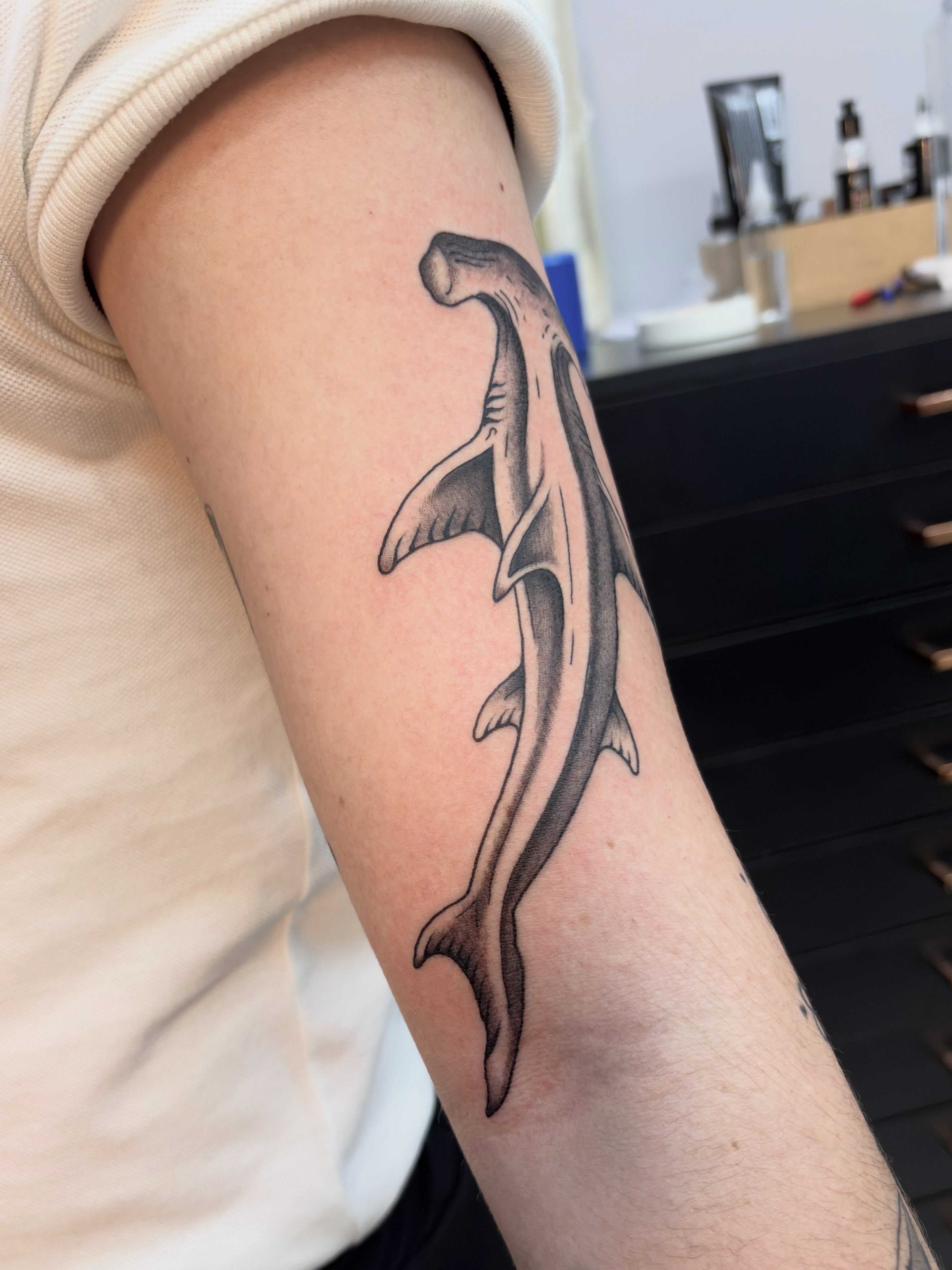 Hammerhead shark black and grey tattoo on the forearm by Lucas Naganuma