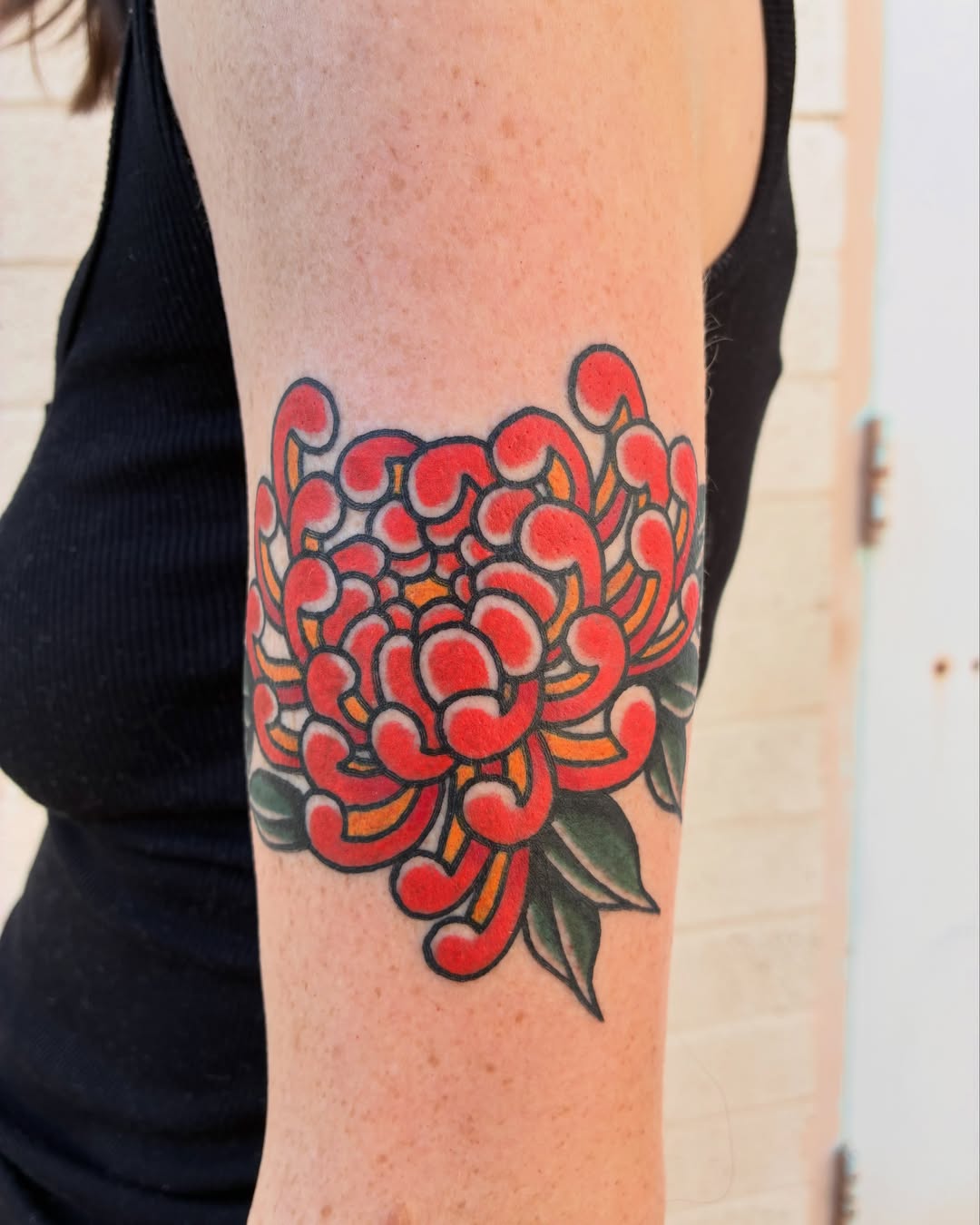 Chrysanthemum American traditional tattoo on the forearm by Chrissie