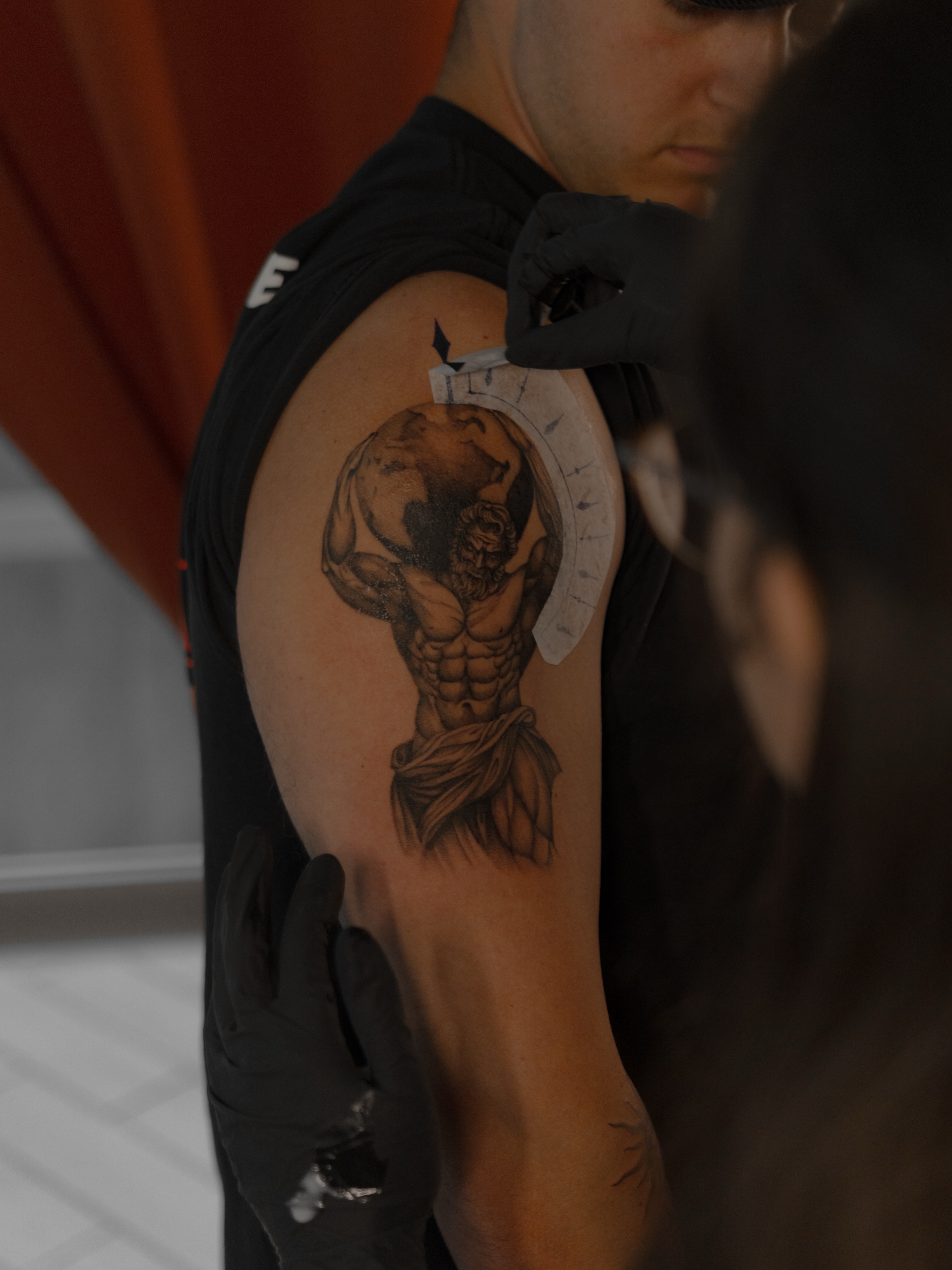 Atlas carrying globe black and grey tattoo on the shoulder by Jen- San Antonio tattoo artist