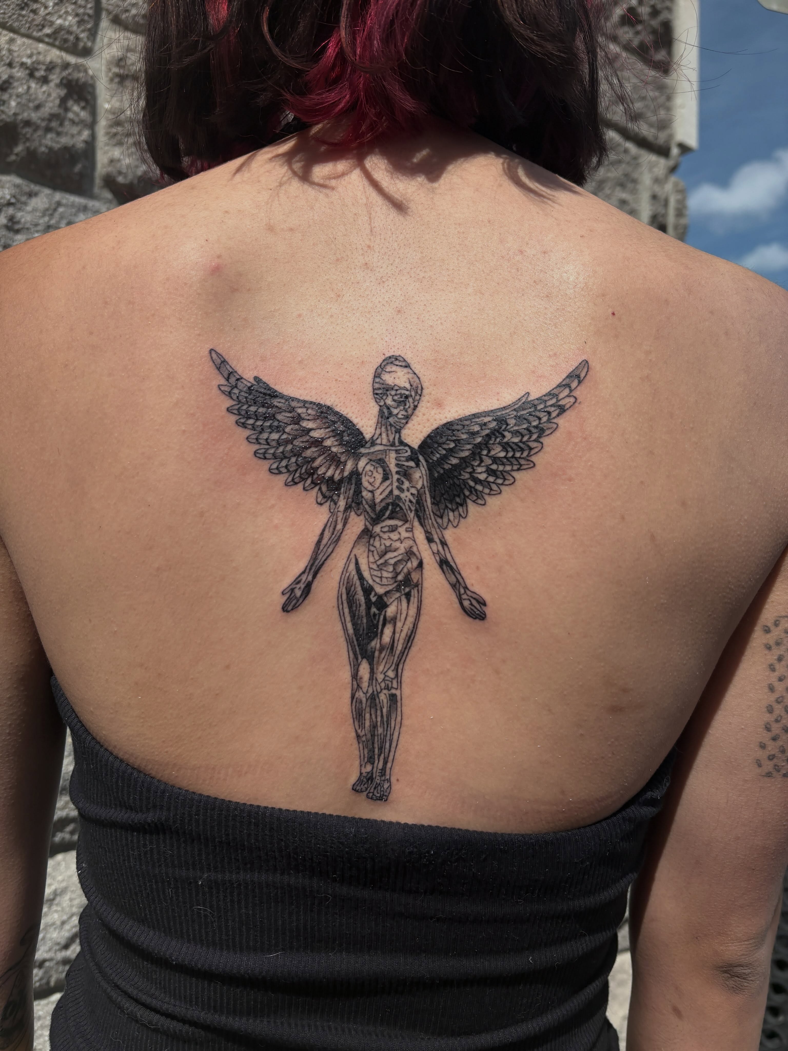 Winged skeleton black and grey tattoo on the back by ⋆.˚ ☾ .⭒˚ alaina