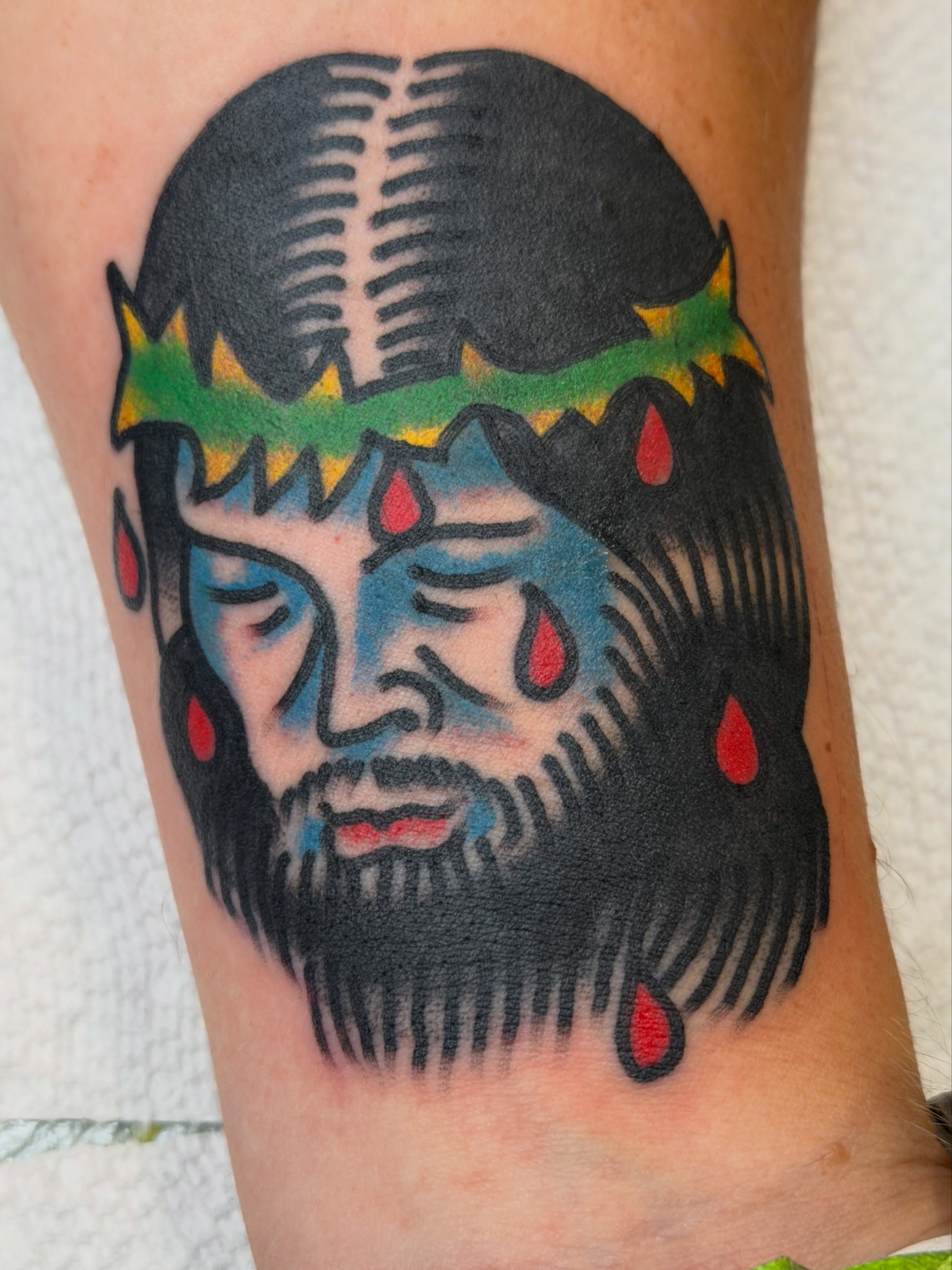Bearded man with crown American traditional tattoo on the forearm by Cody Woolard, Seymour, Tennessee