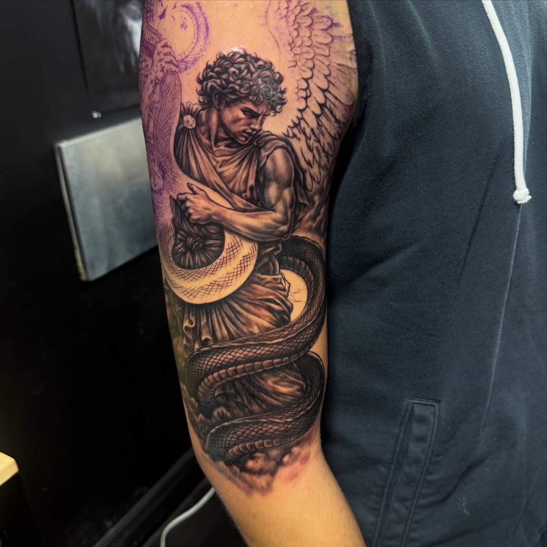 Angel with snake realism tattoo on the forearm by Kiefer Fonseca