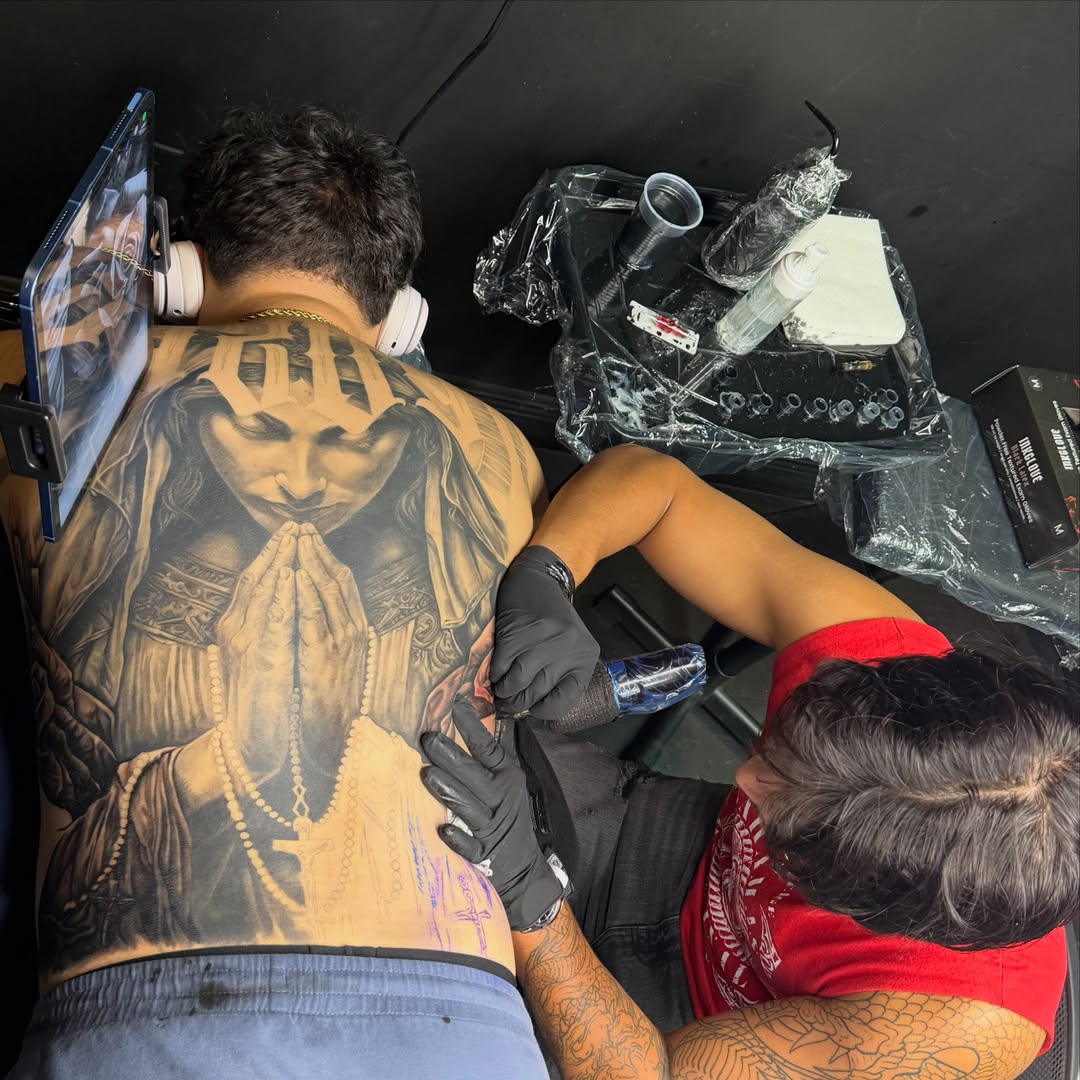 Religious figure praying realism tattoo on the back by Kiefer Fonseca