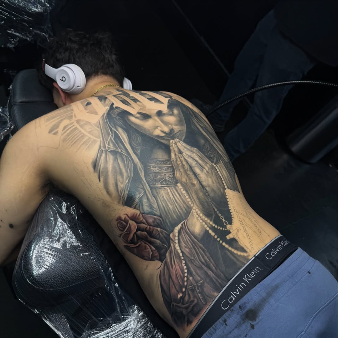 Religious figure praying realism tattoo on the back by Kiefer Fonseca