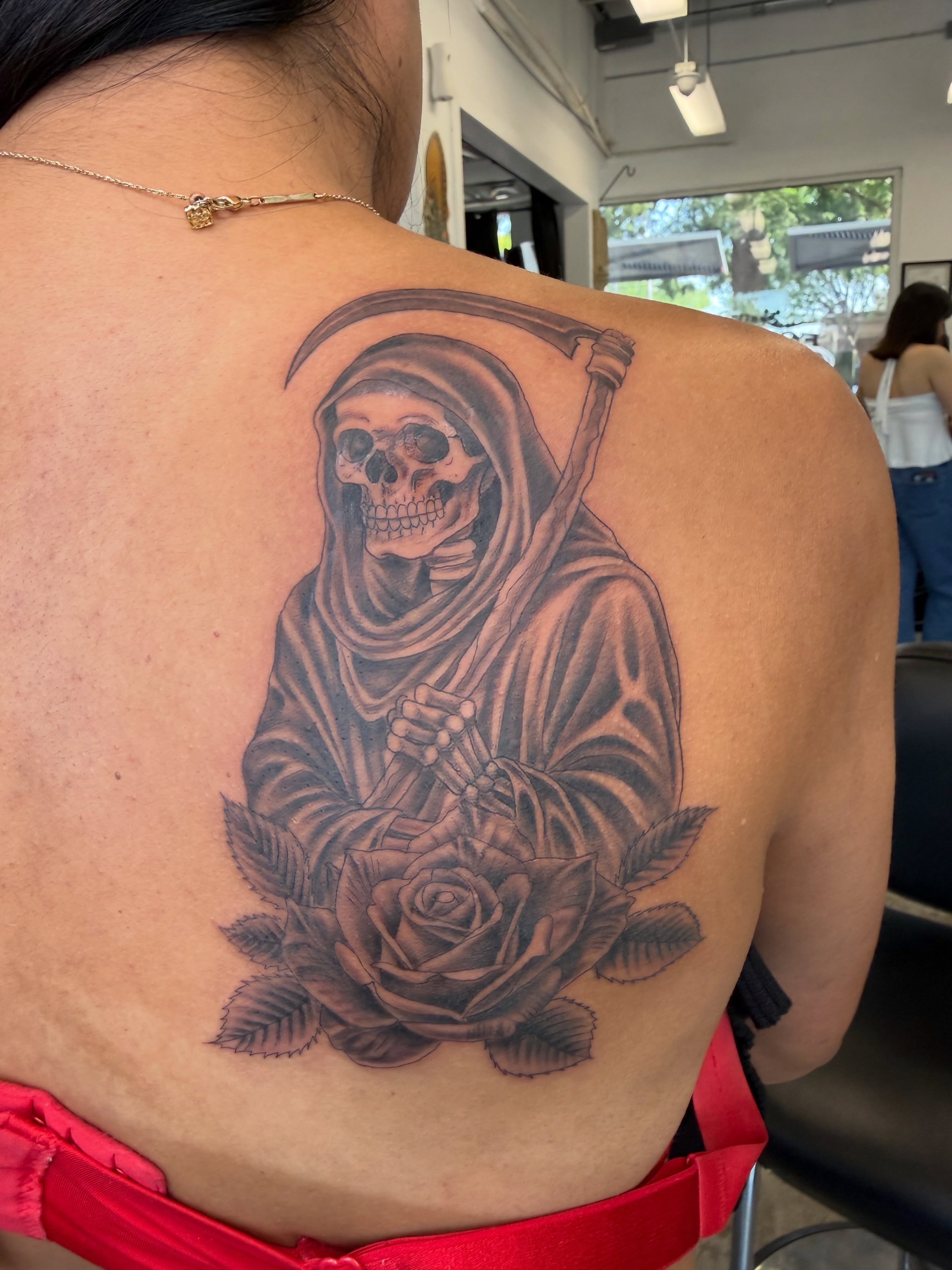 Grim reaper with rose realism tattoo on the back by Ricky Sanchez, Duncanville, Texas