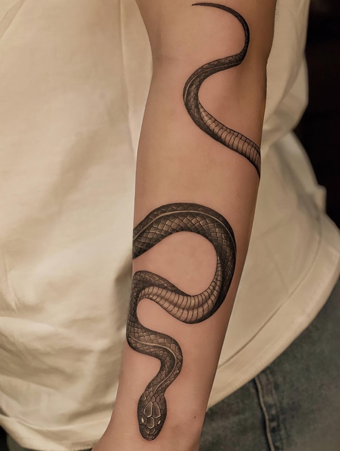 Snake black and grey tattoo on the forearm by Damon_modoink