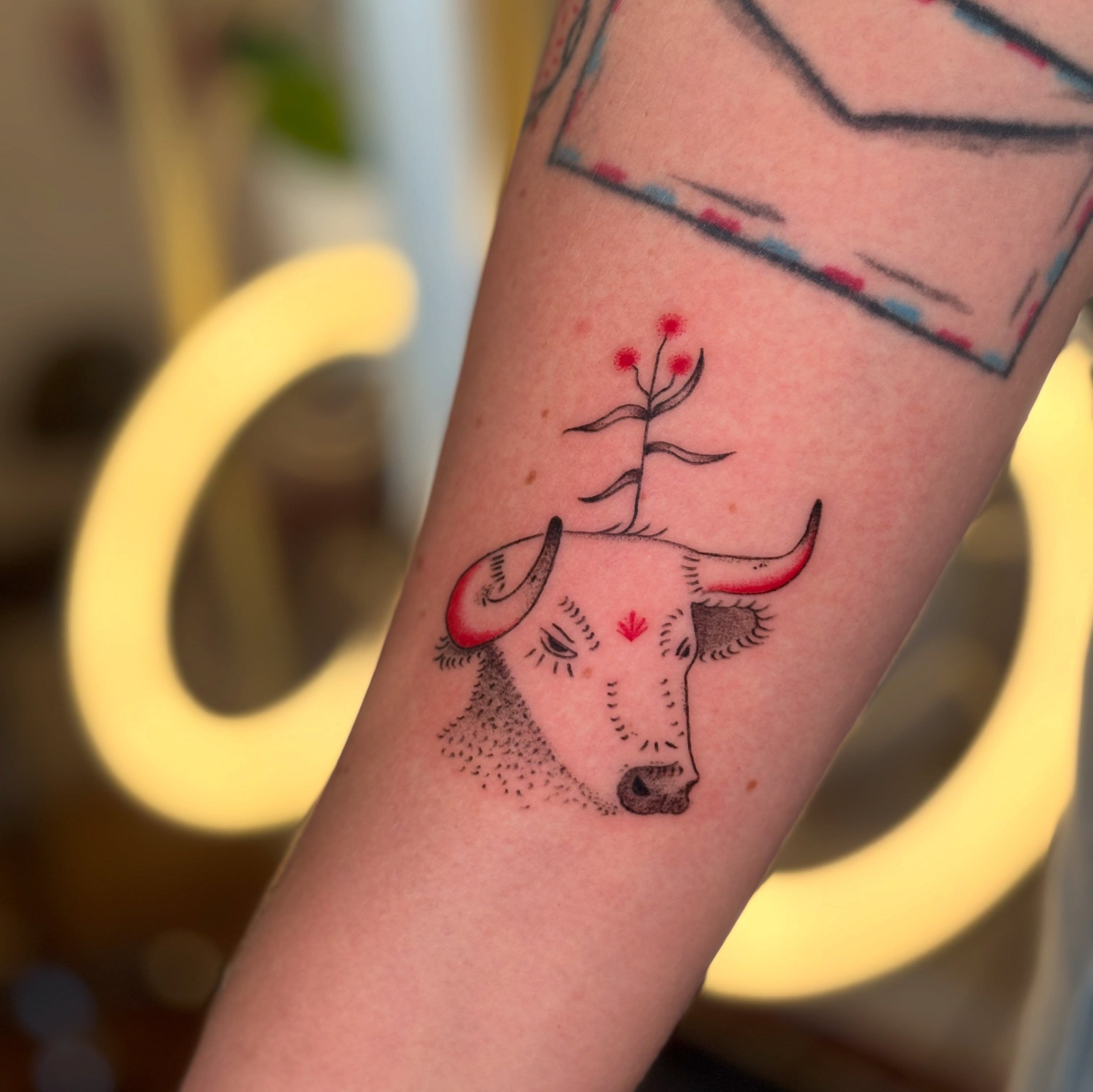 Bull head with flowers geometric tattoo on the forearm by carla sofia