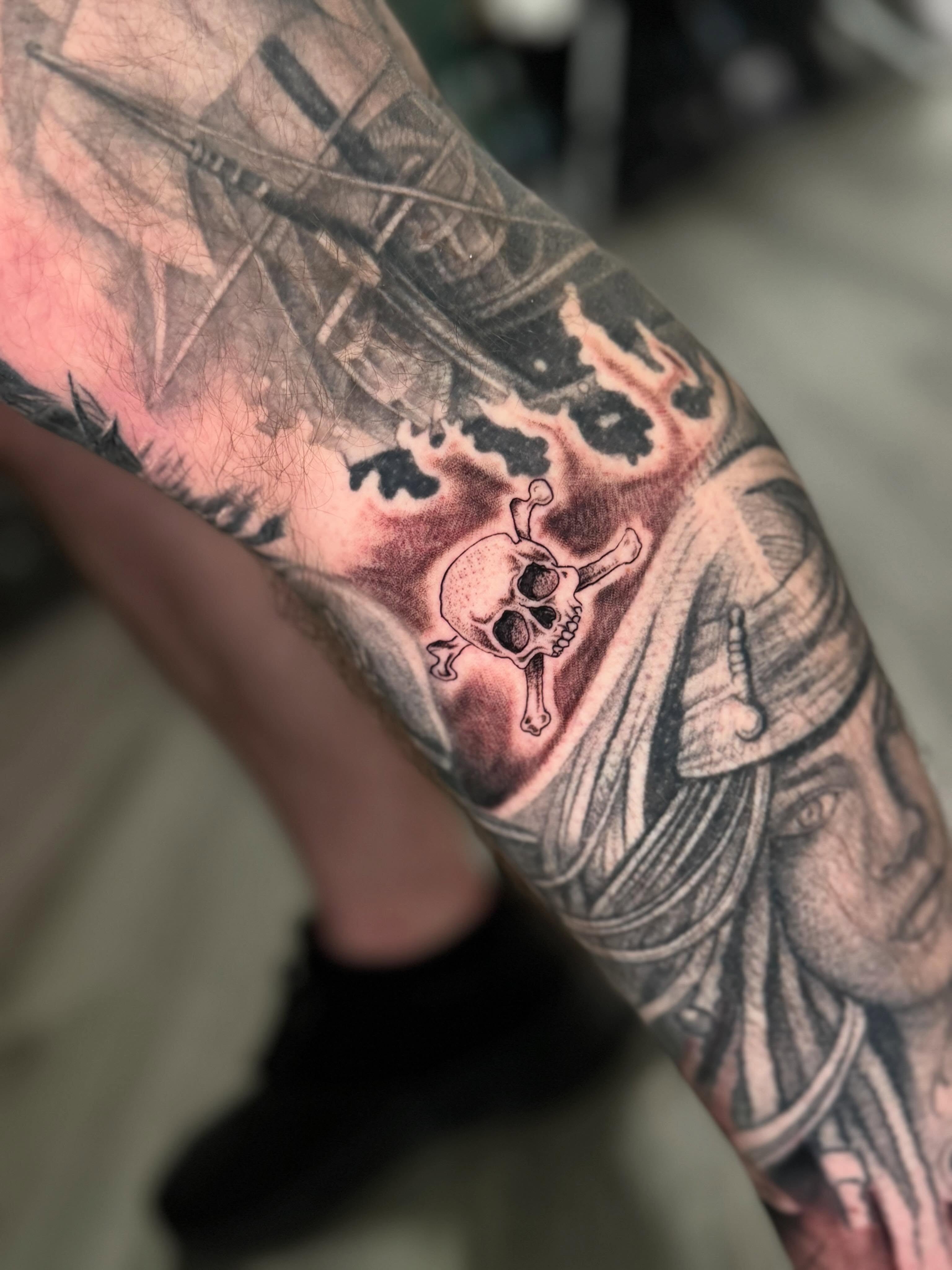 Pirate ship and skull realism tattoo on the forearm by Adrián Banuelos