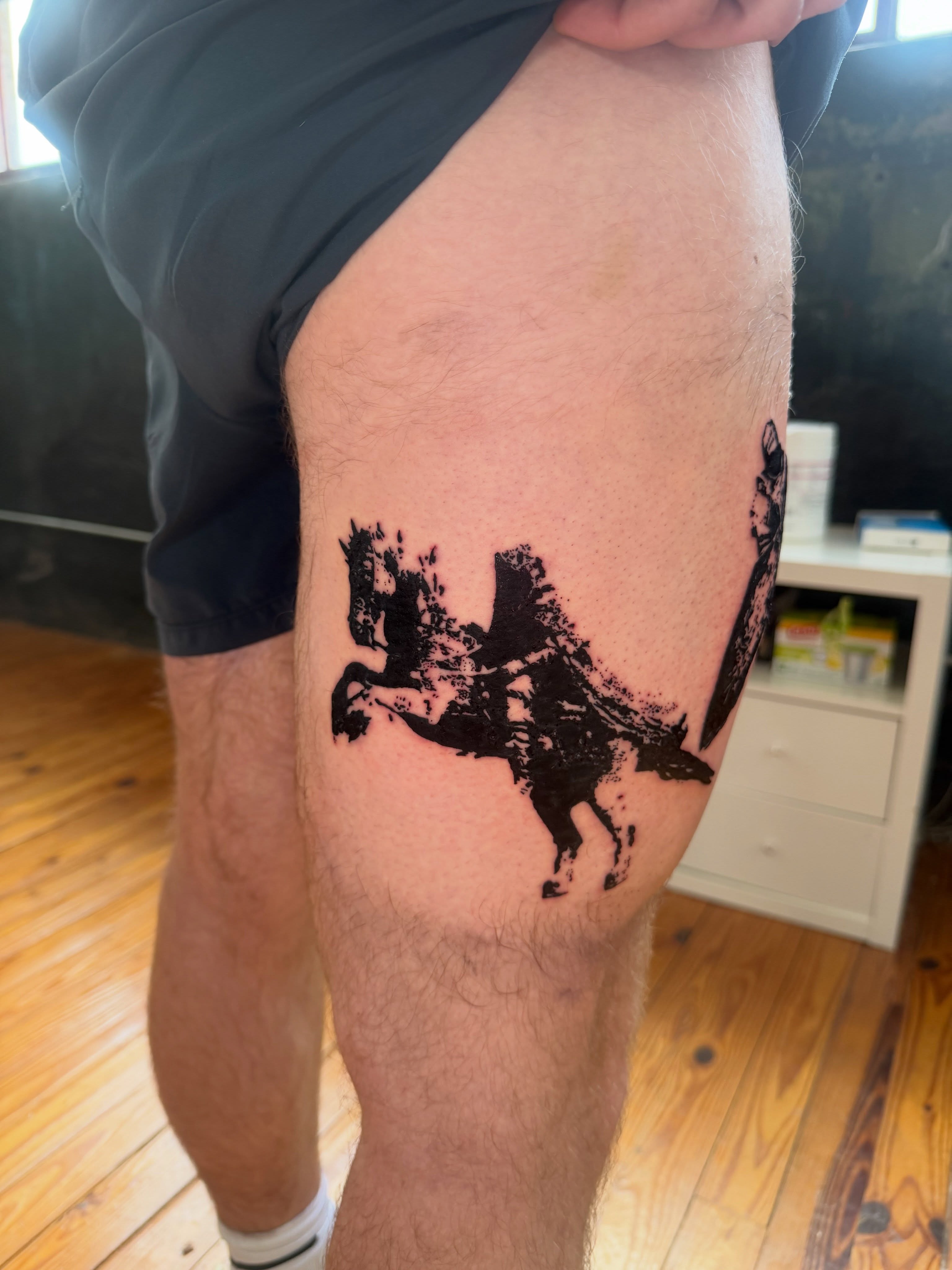 Horse and rider black and grey tattoo on the thigh by Jose Javier