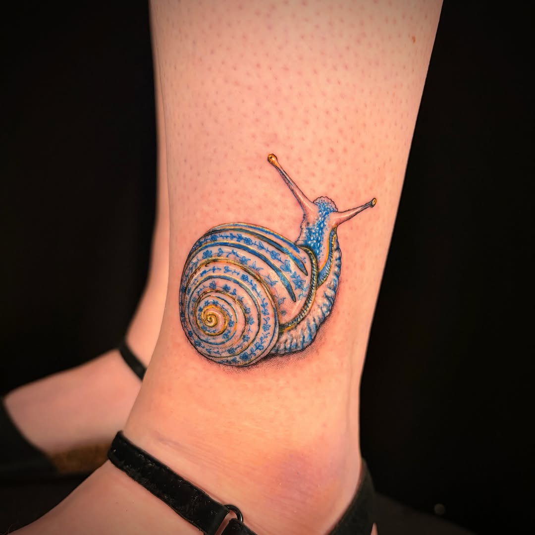 Snail realism tattoo on the forearm by Jessica Sheahan