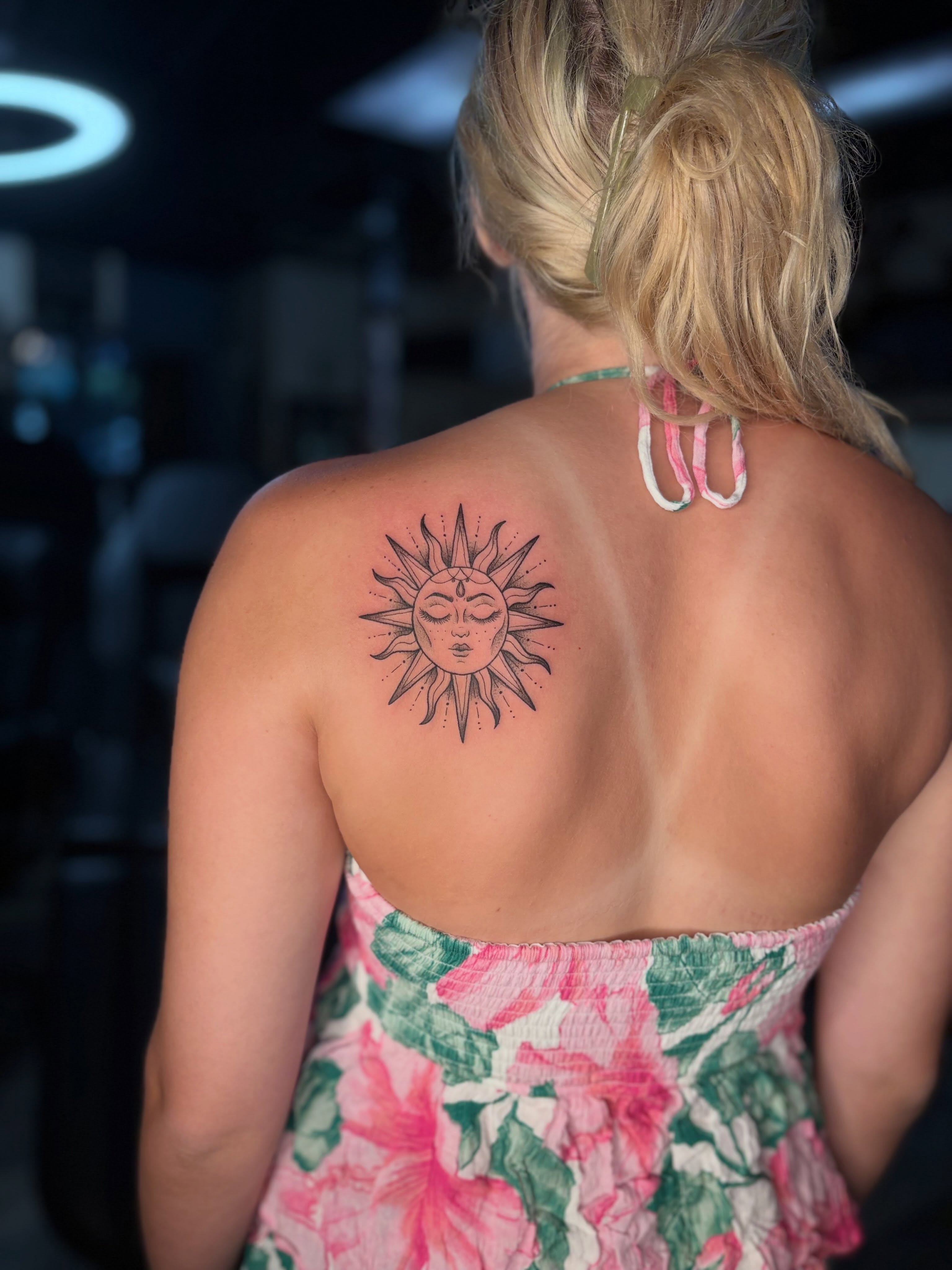 Sun with face geometric tattoo on the back by Tessa Simmons - Tattoo Artist