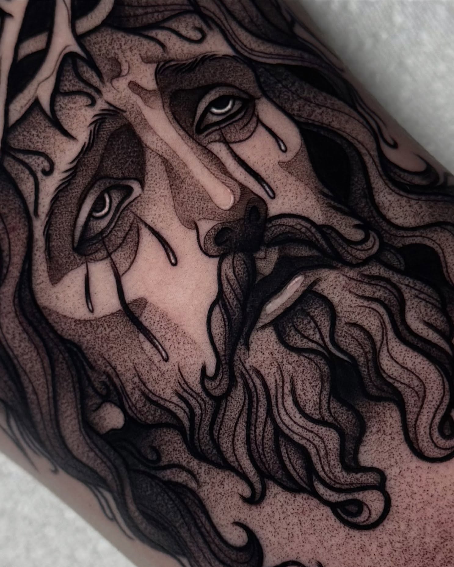 Religious figure dotwork tattoo on the forearm by Bell Bolton