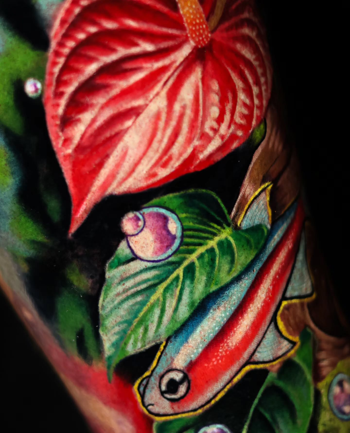 Fish and leaf American traditional tattoo on the upper arm by Ciani Holman