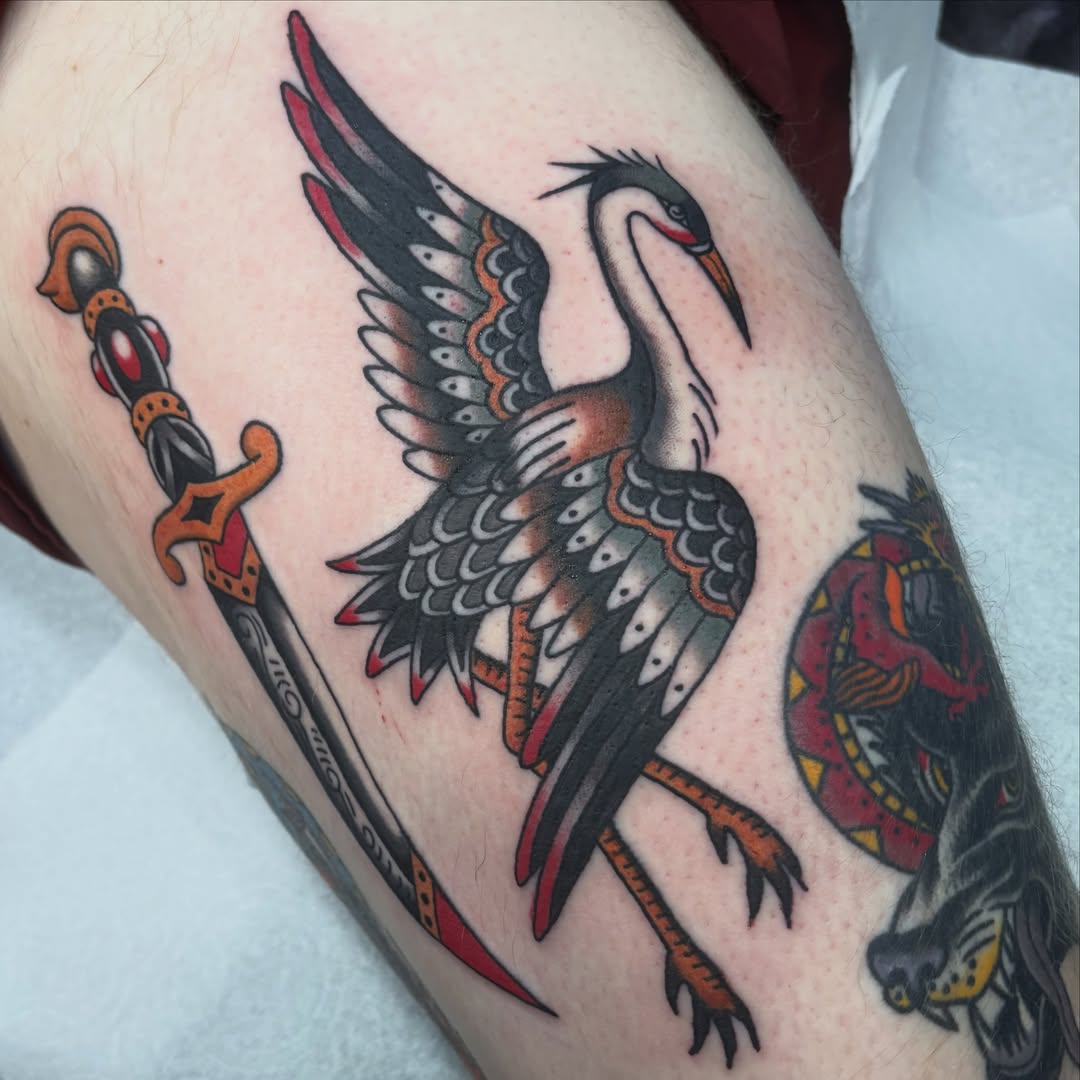 Heron and sword American traditional tattoo on the thigh by Lindsey Cam Van