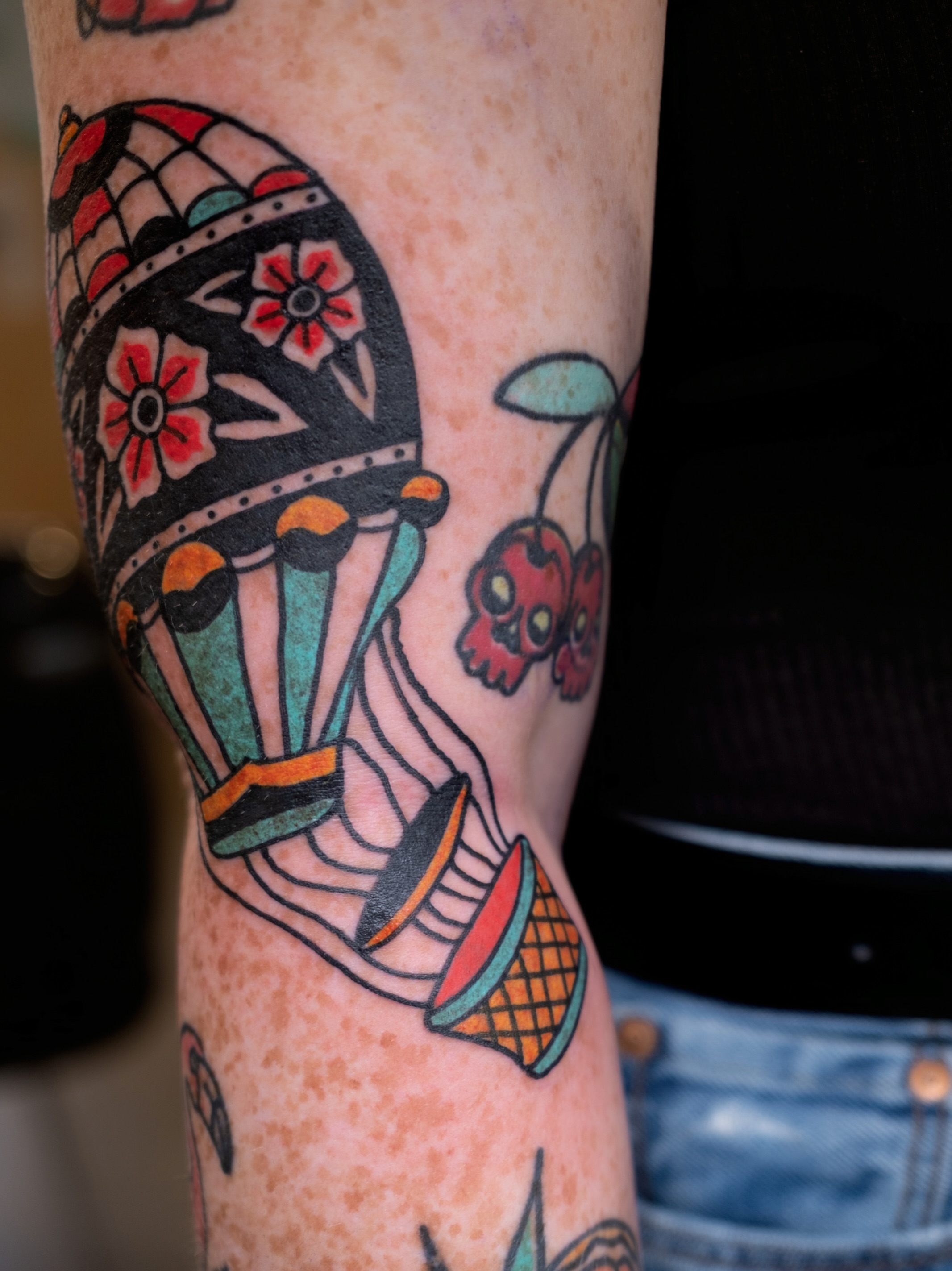 Balloon and flowers American traditional tattoo on the forearm by Neto Velasco - Sad Cat Tattoo, Austin, Texas