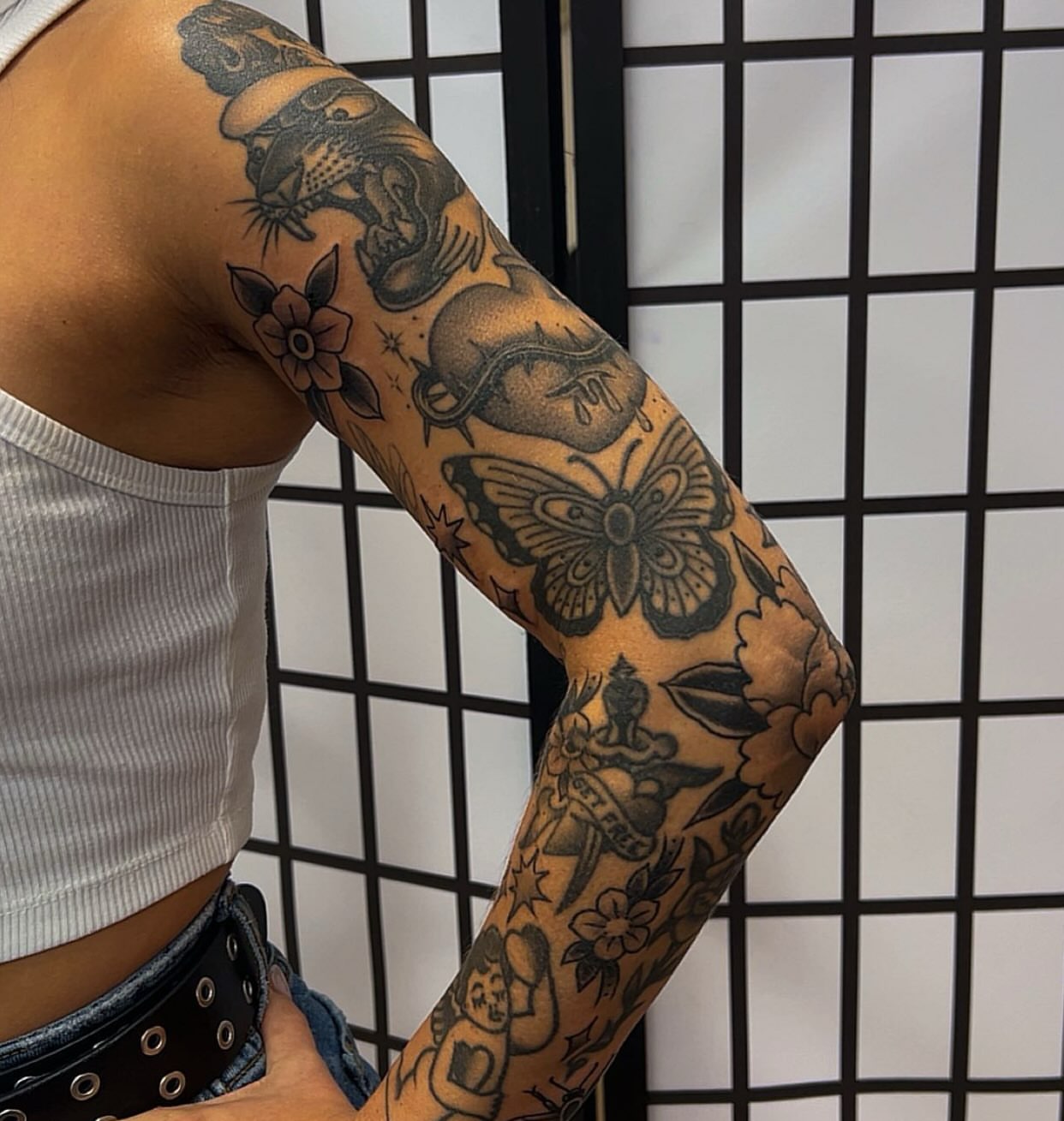 Butterfly and flowers American traditional tattoo on the forearm by Chris Romolini