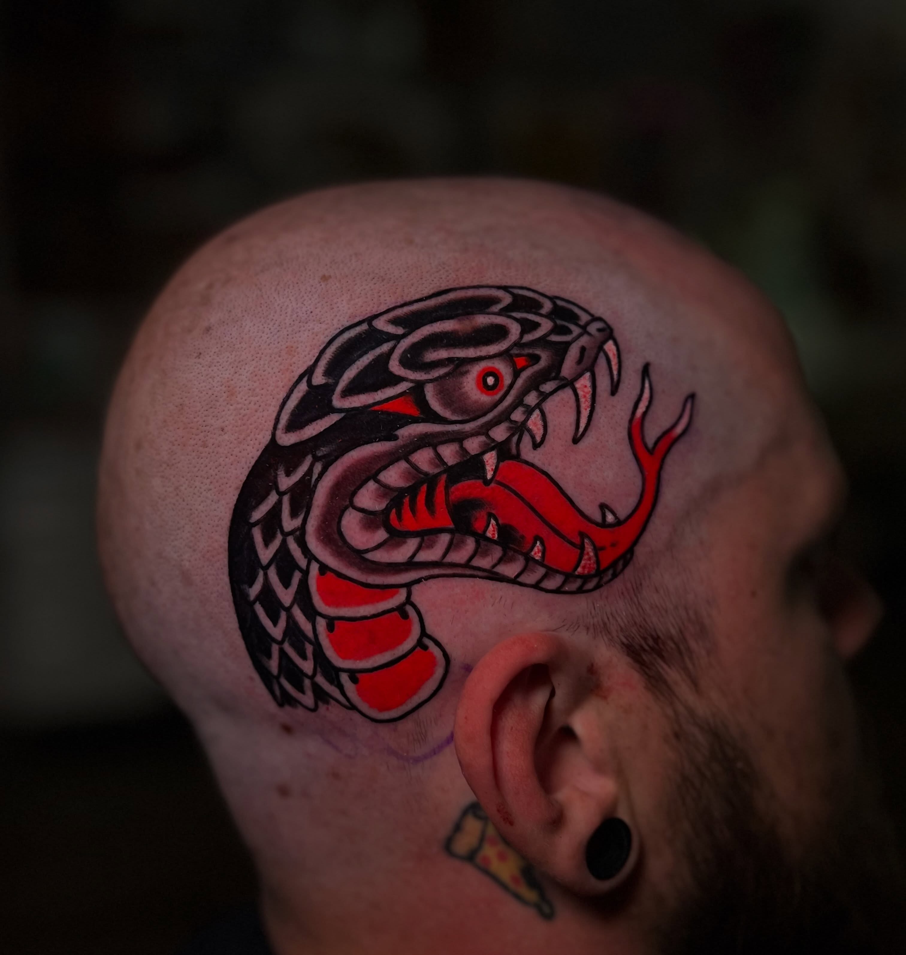 Snake American traditional tattoo on the head by Chris Romolini