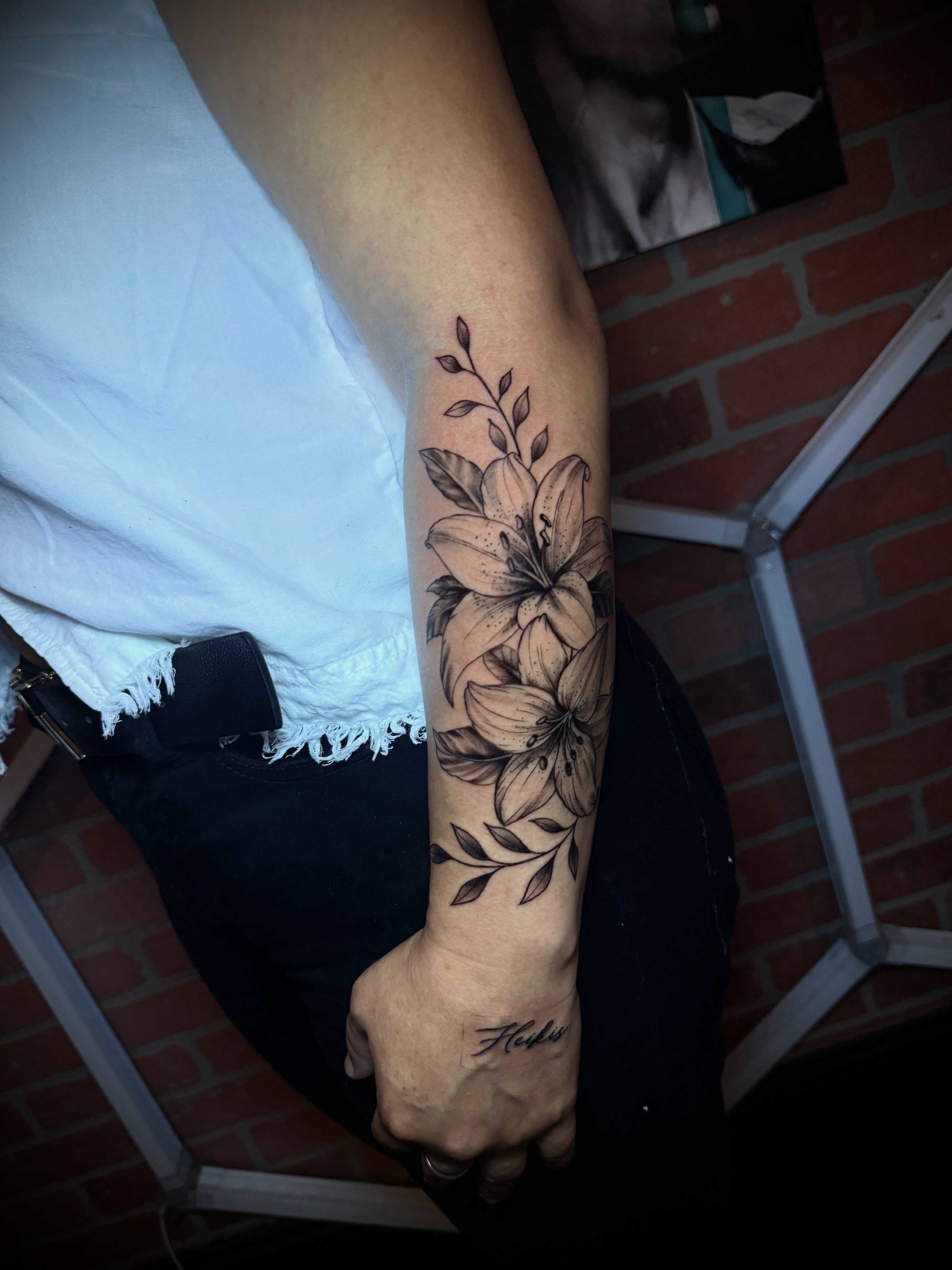 Lily flowers black and grey tattoo on the forearm by Andres Calvo🇺🇸🇨🇴