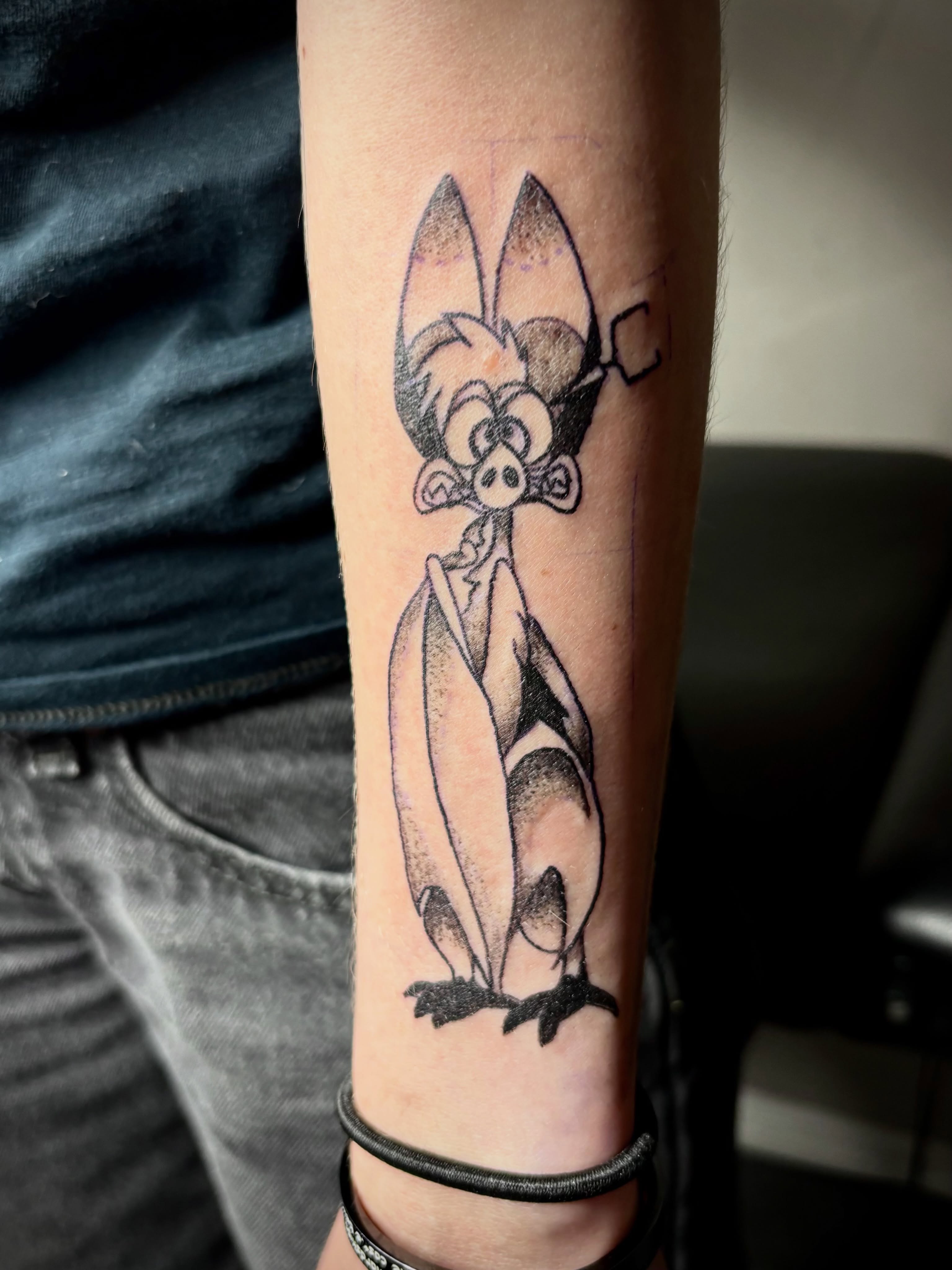 Pig character black and grey tattoo on the forearm by Rayne